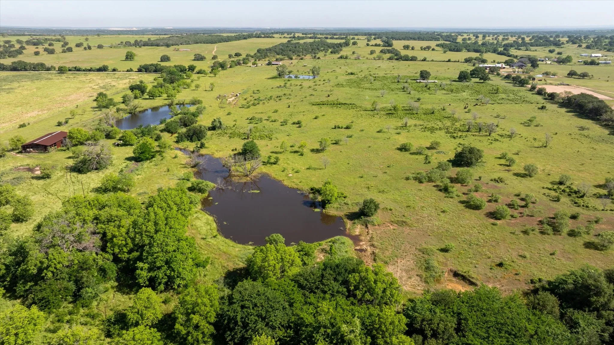 Another aerial view from the back of the property. You see all three ponds and the barn from here.