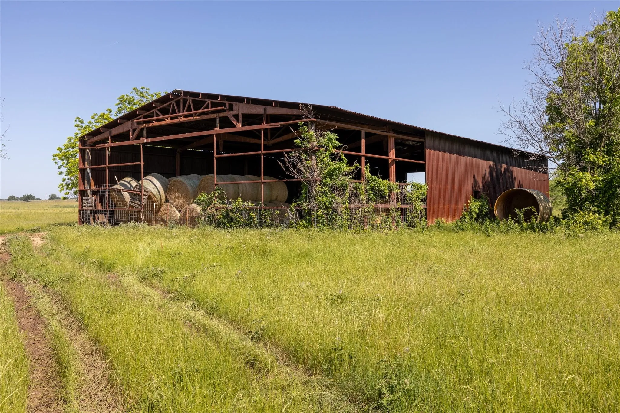 Back side of the barn. There is leftover sheet metal on the property that can be used to finish enclosing the barn.