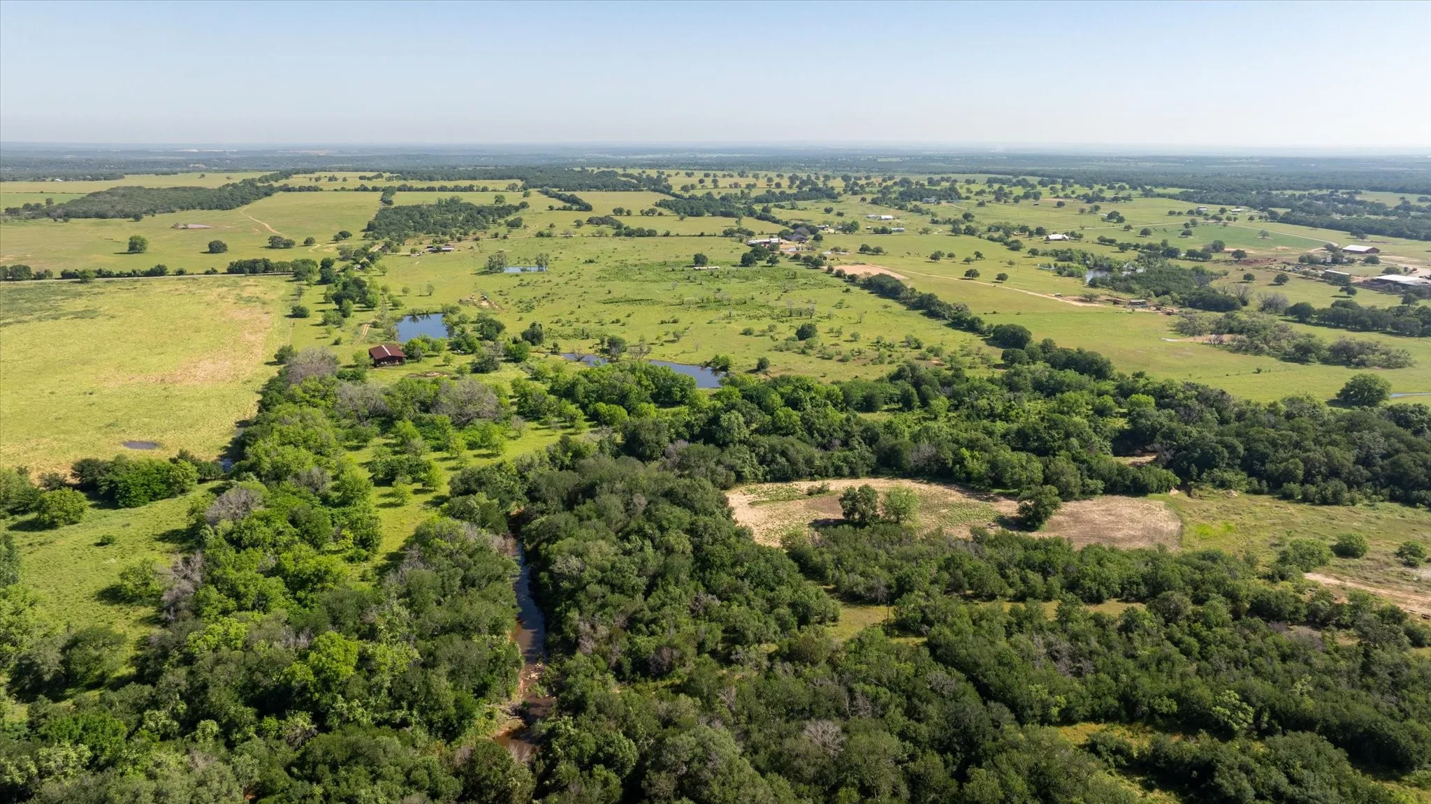 Aerial view from the South side of the property. You can see Kickapoo Creek which runs along and through the property line.