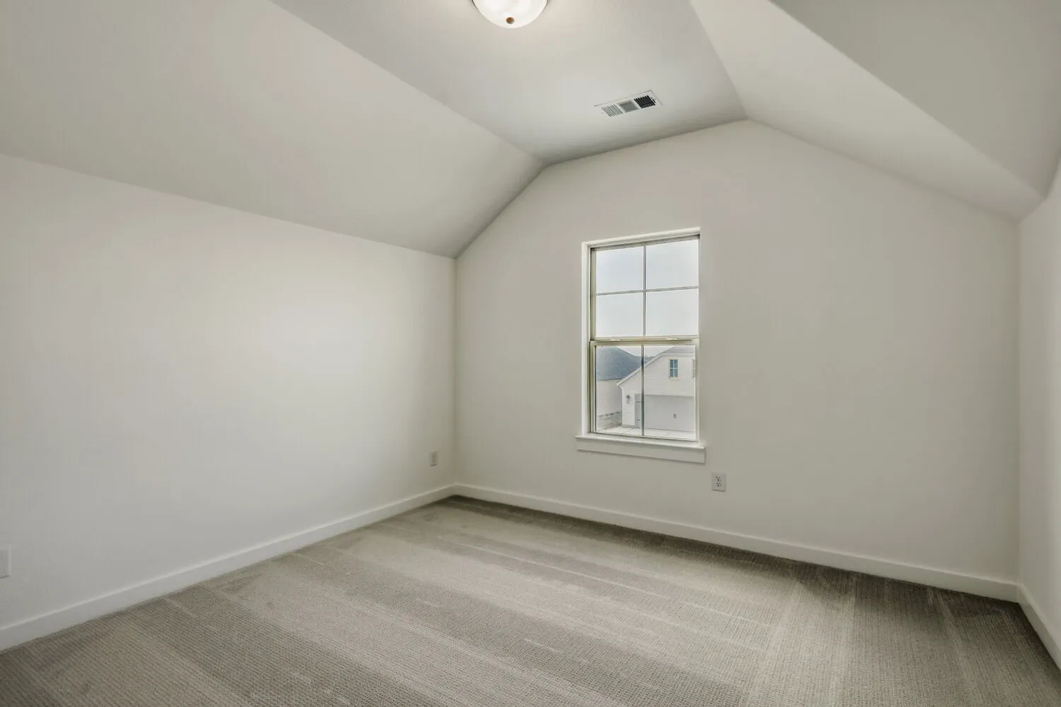 Bonus room featuring light colored carpet and baseboards