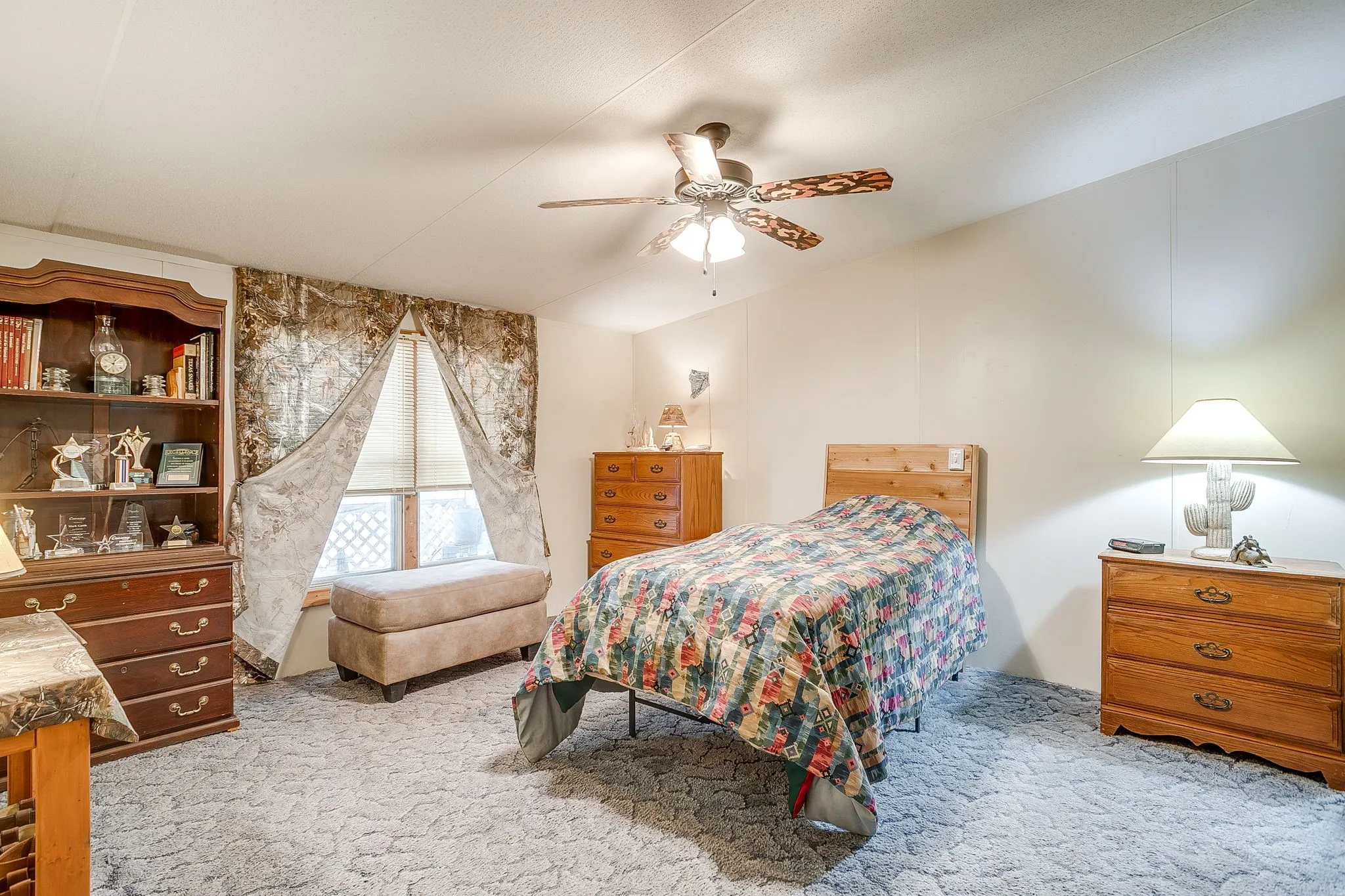Bedroom featuring light carpet and ceiling fan