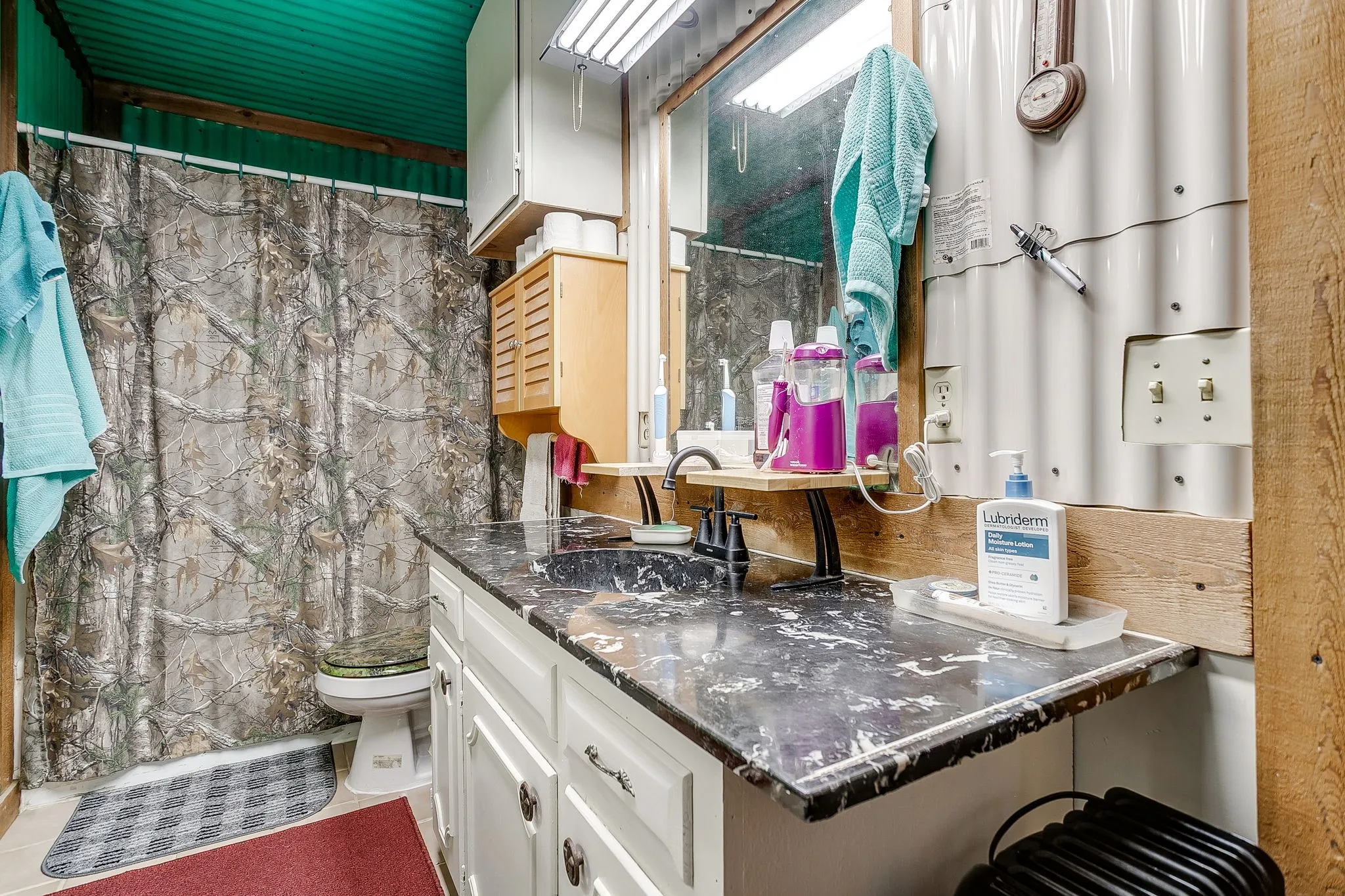 Bathroom featuring vanity and curtained shower