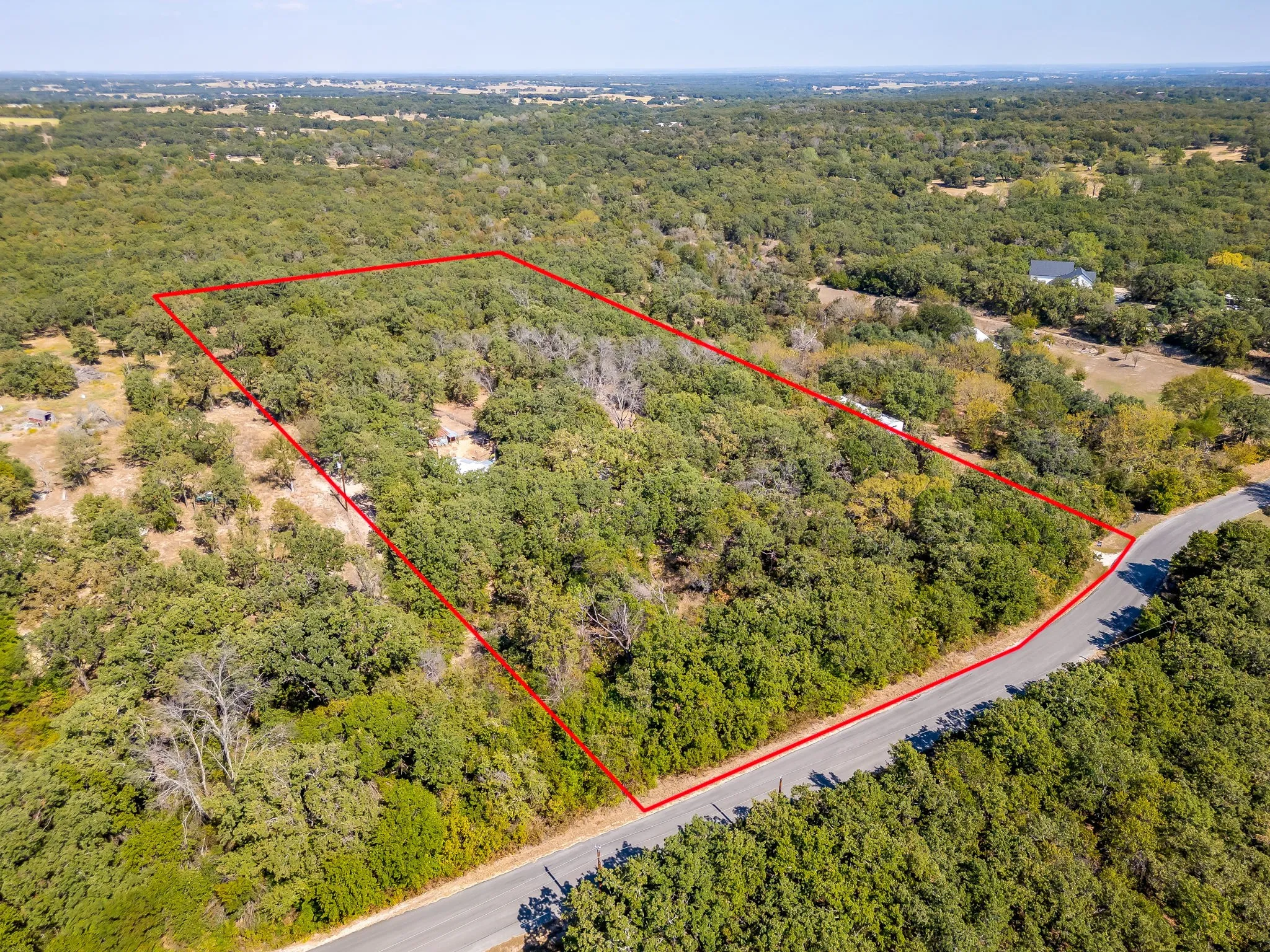 Aerial view of property's location with a forest and property boundaries highlighted