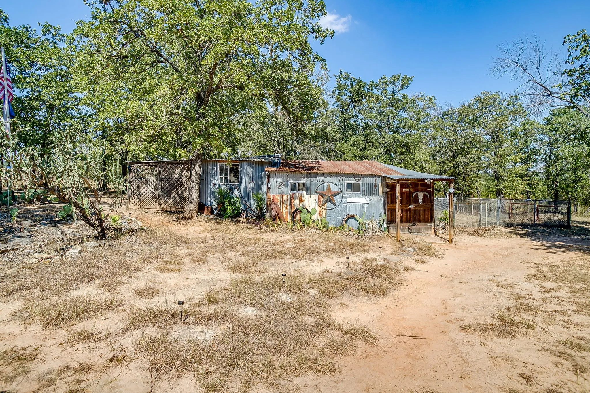 View of front of house with view of scattered trees