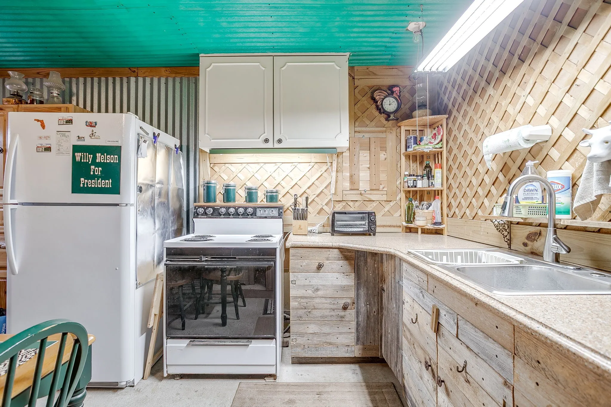 Kitchen with white appliances, light countertops, tasteful backsplash, and open shelves