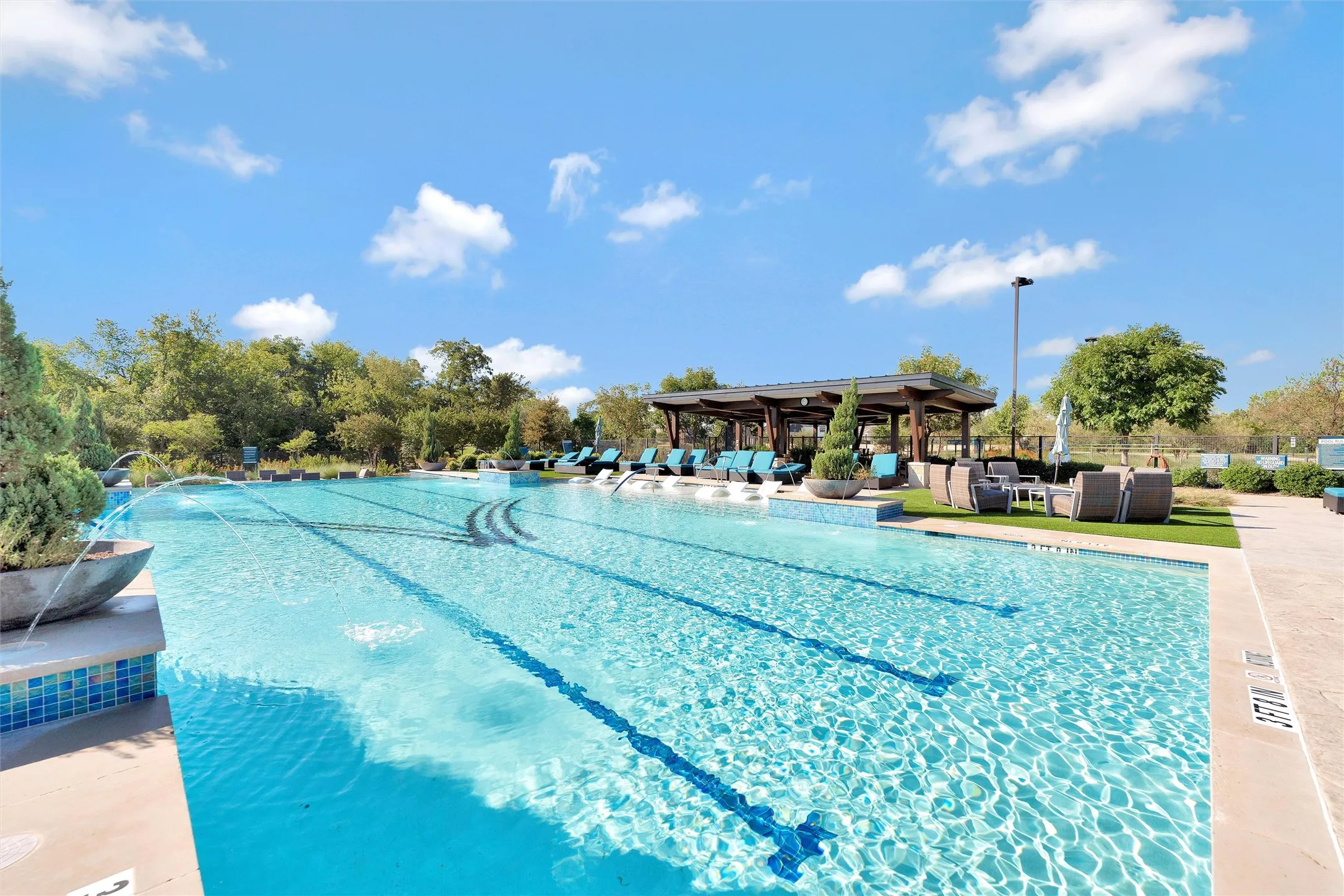 Community pool with a patio