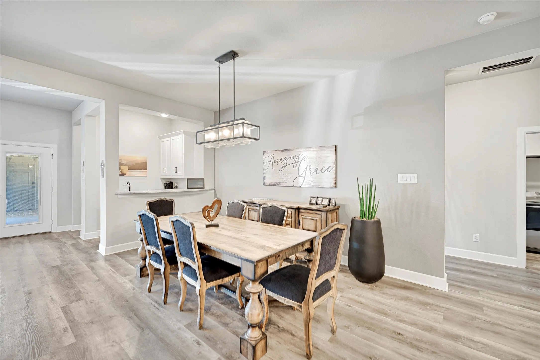 Dining space with light wood-type flooring and baseboards