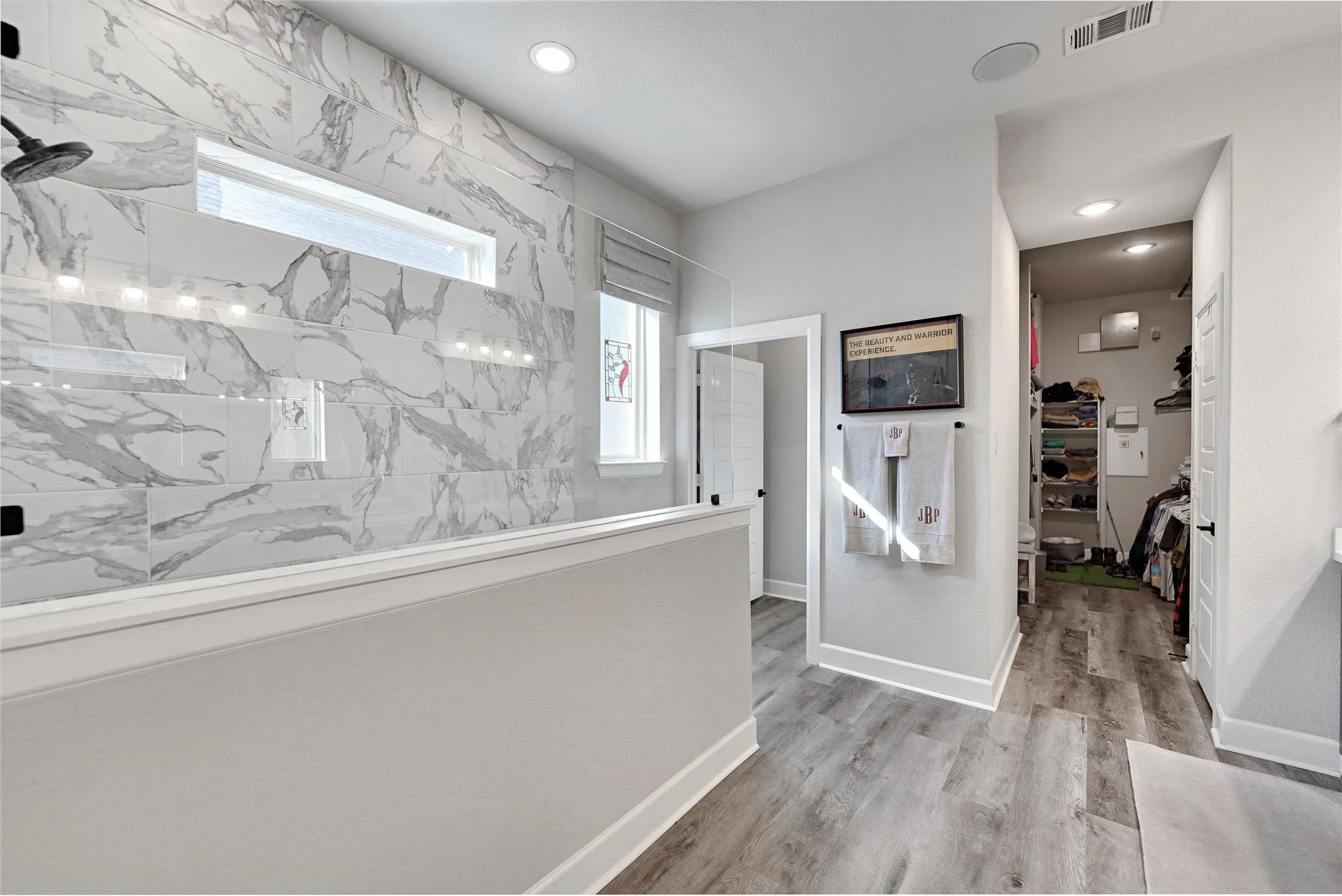 Hall featuring light wood finished floors and recessed lighting