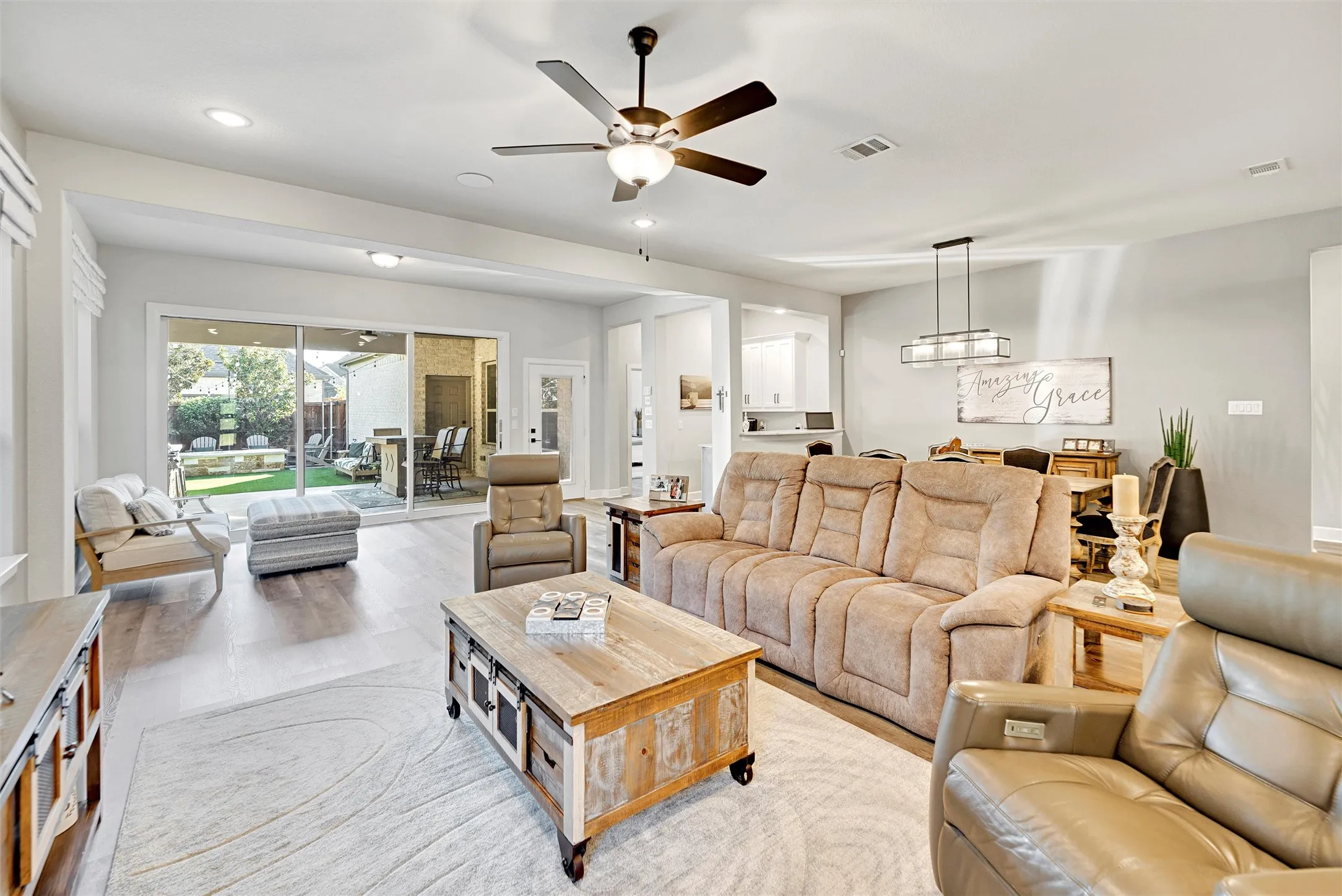 Living area featuring a ceiling fan, recessed lighting, and wood finished floors