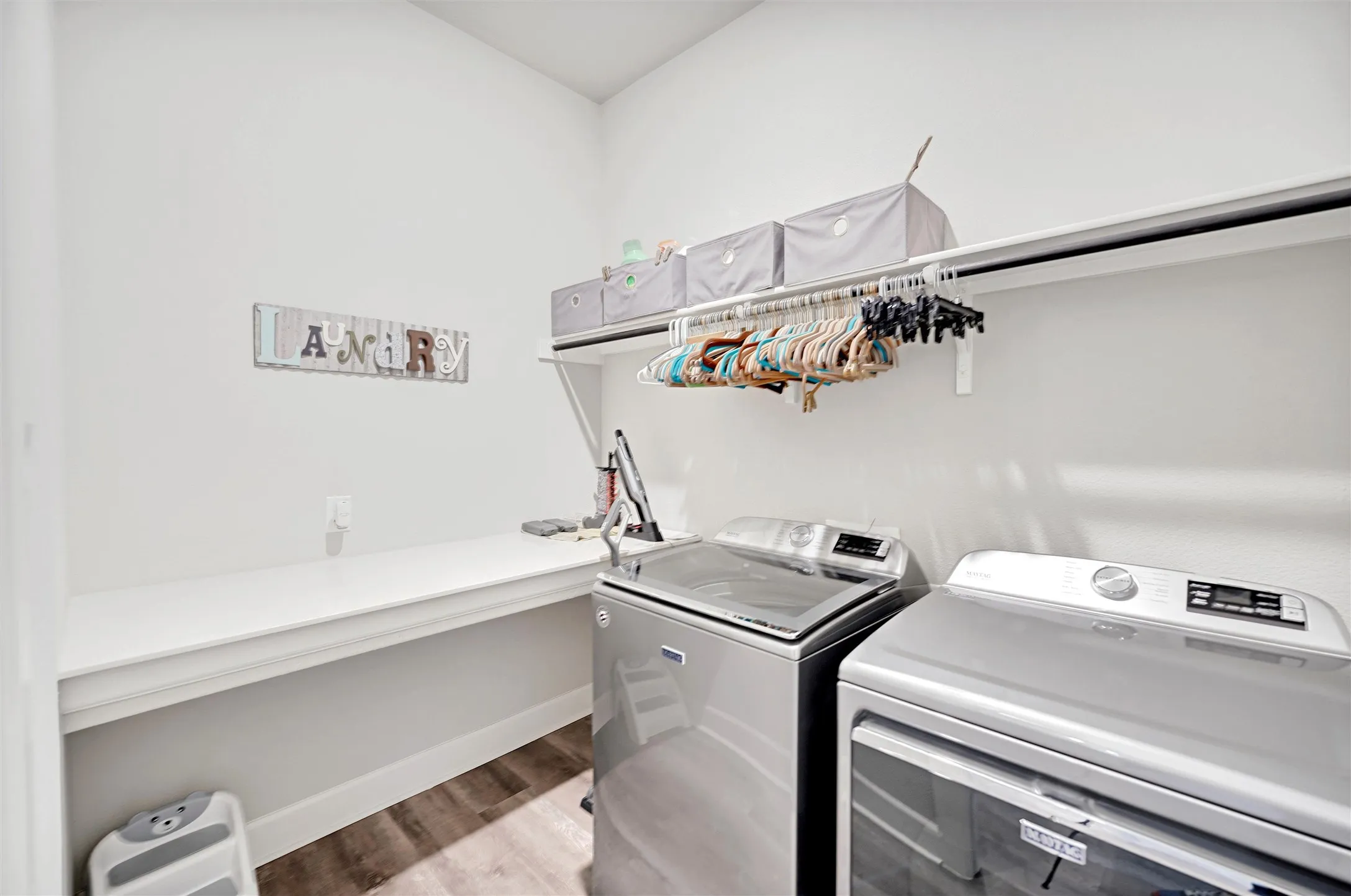 Laundry area featuring light wood-style floors and independent washer and dryer
