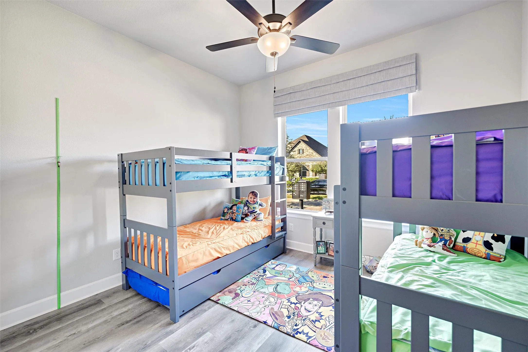 Bedroom with wood finished floors and ceiling fan