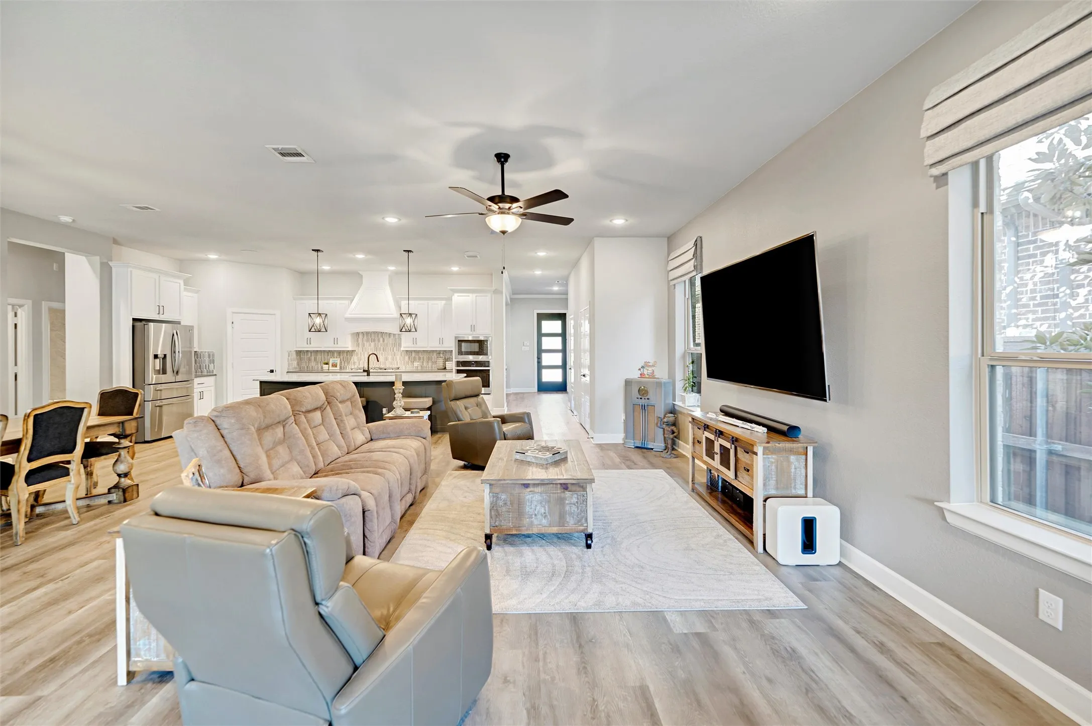 Living area featuring light wood-style flooring, recessed lighting, and a ceiling fan