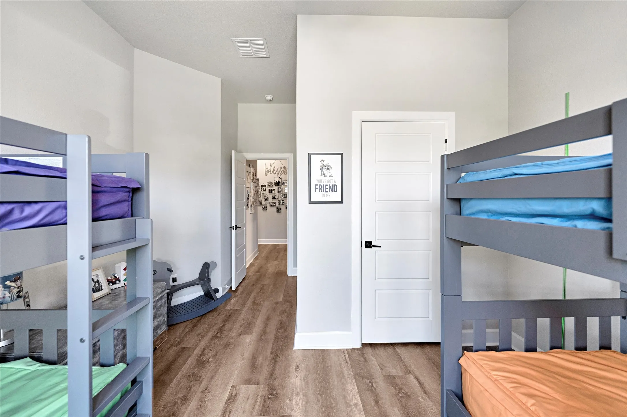 Bedroom with light wood-style floors and baseboards