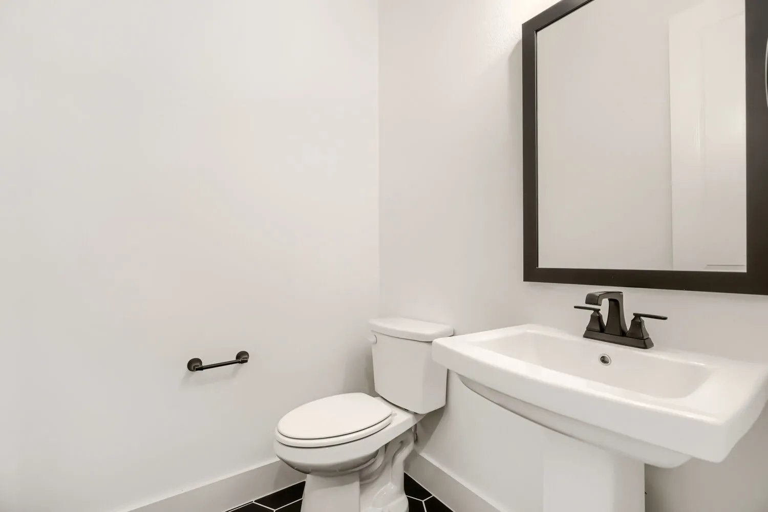 Bathroom with baseboards and tile patterned flooring
