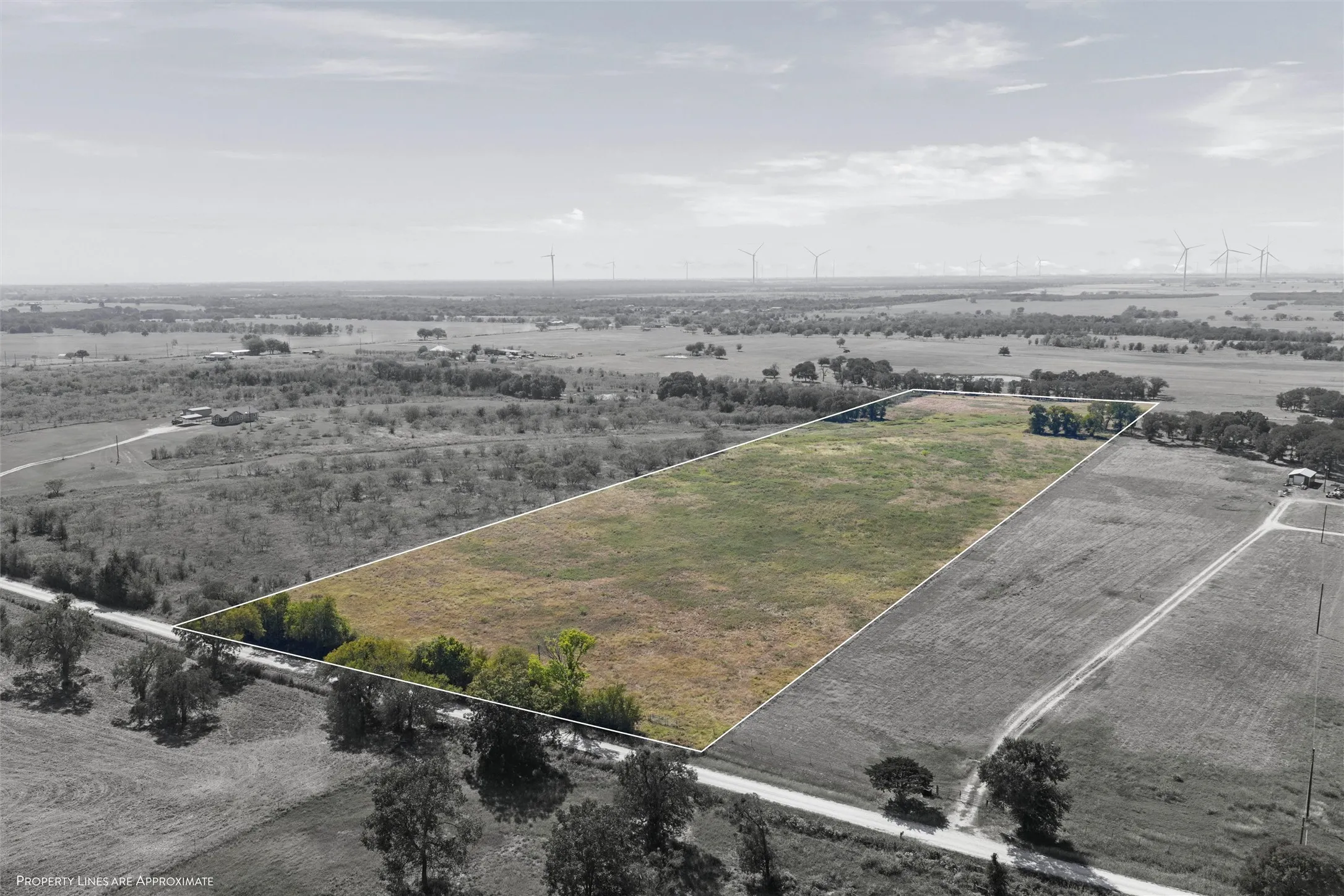 Aerial view of sparsely populated area featuring property boundaries highlighted