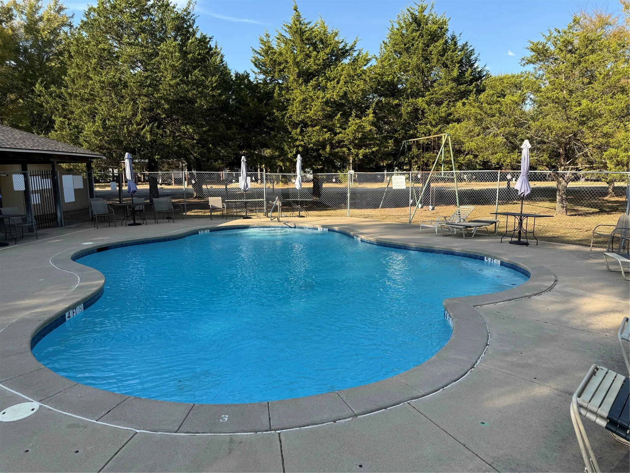 Community pool with a patio area
