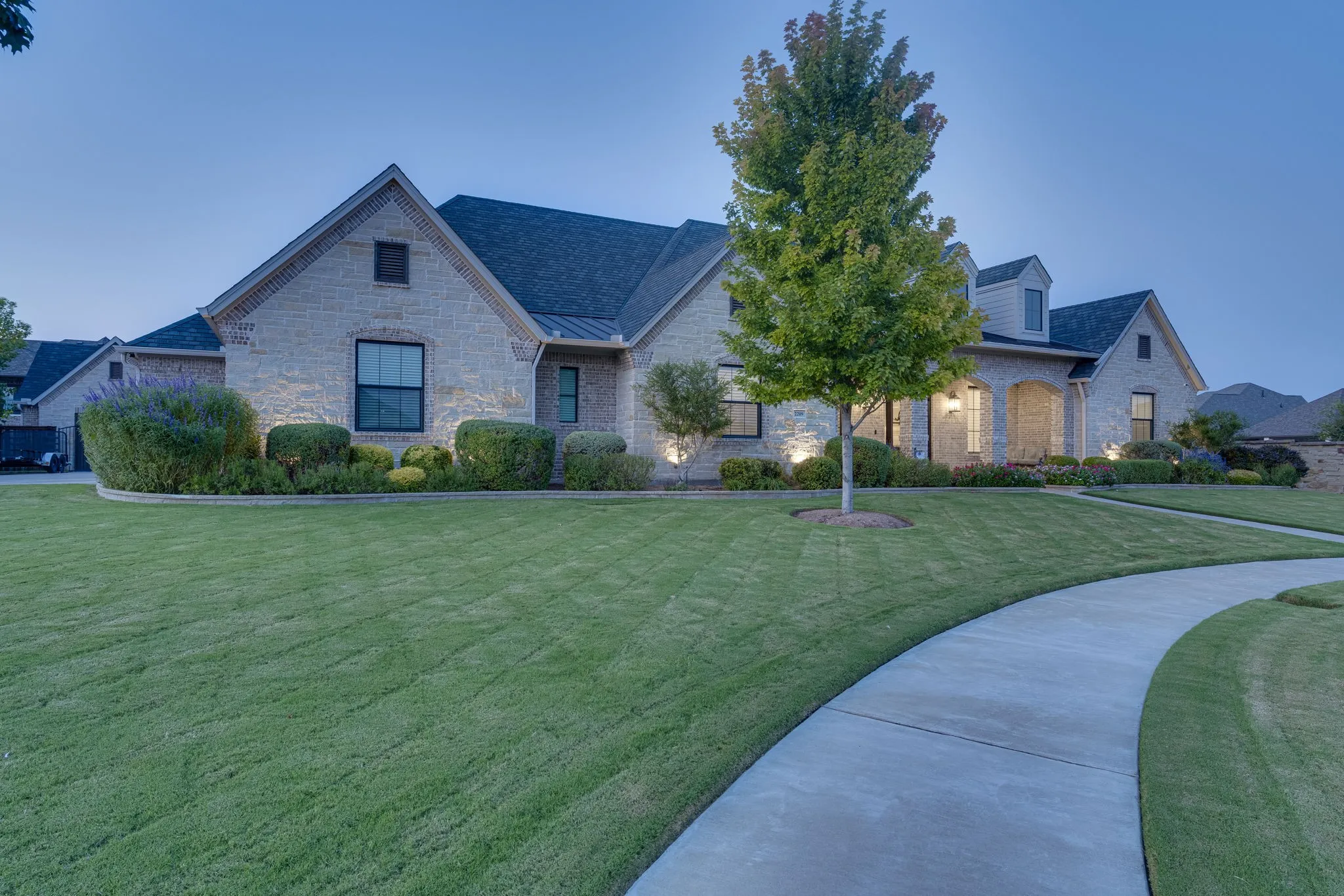 French country home featuring a front yard and stone siding
