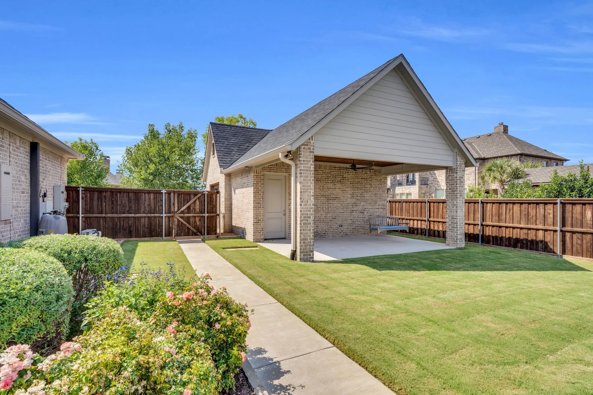 Rear view of property featuring a fenced backyard, a patio, brick siding, and a ceiling fan