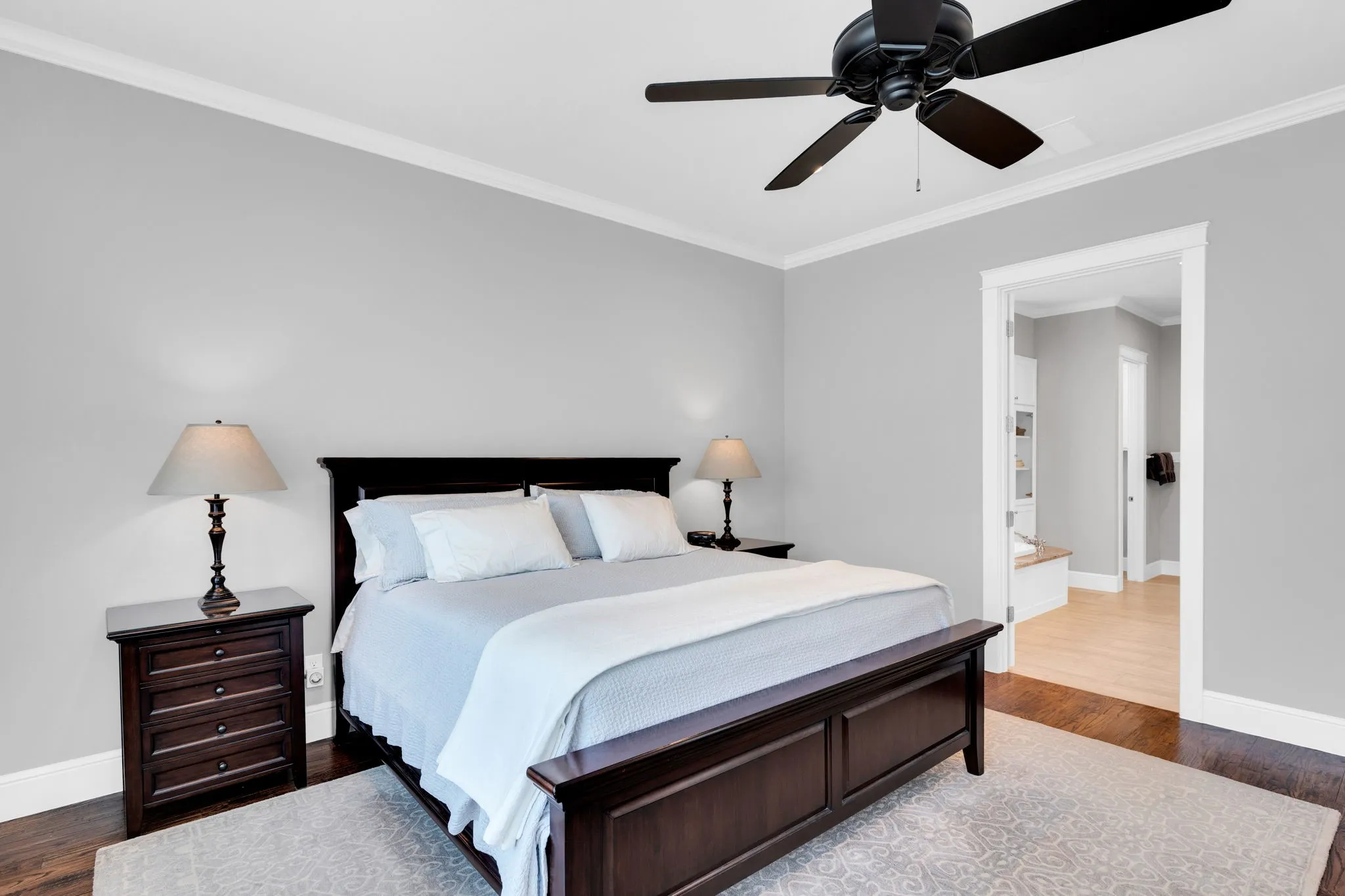 Bedroom featuring crown molding, dark wood-type flooring, and ceiling fan