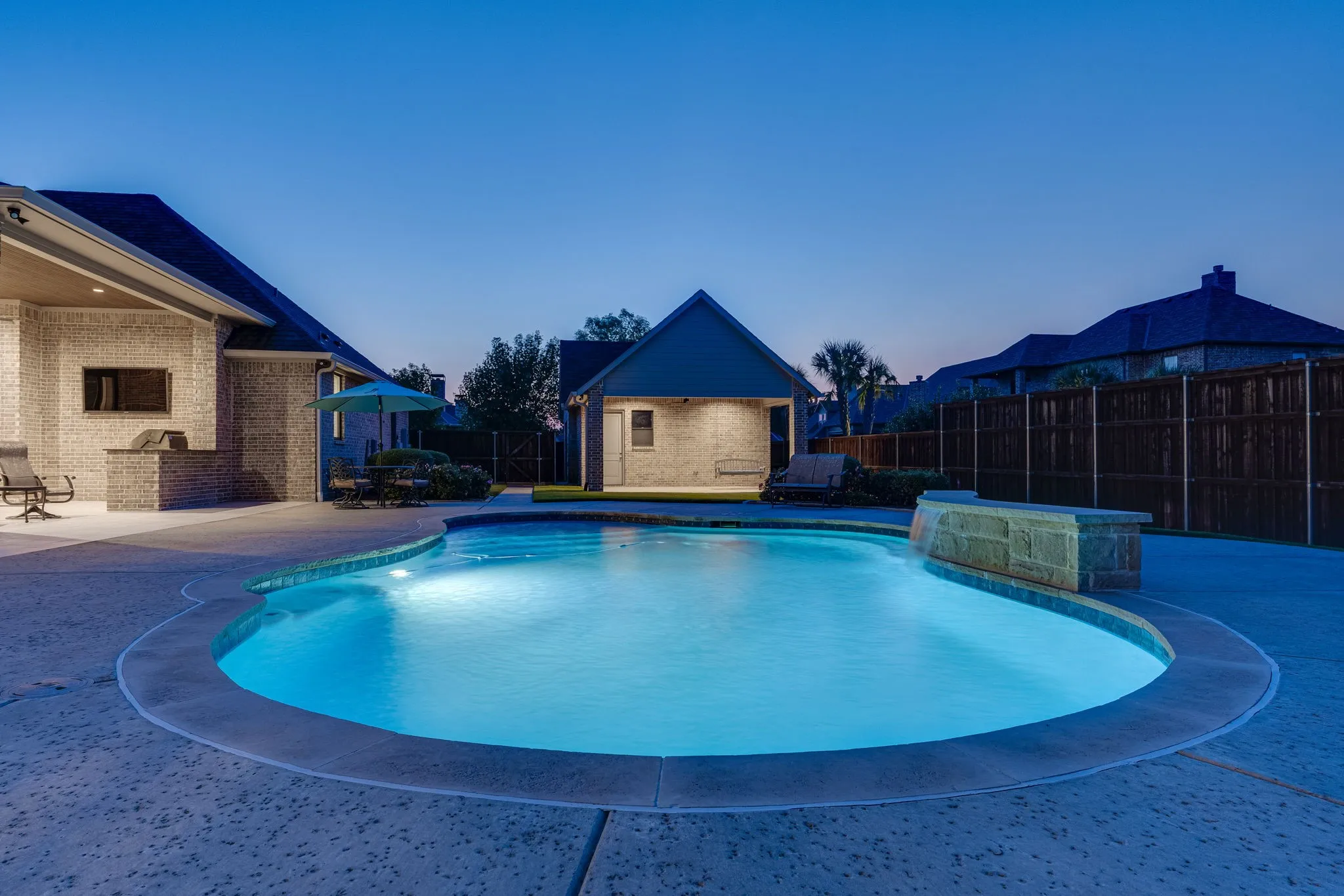 View of pool with a fenced backyard, a patio, and an outbuilding