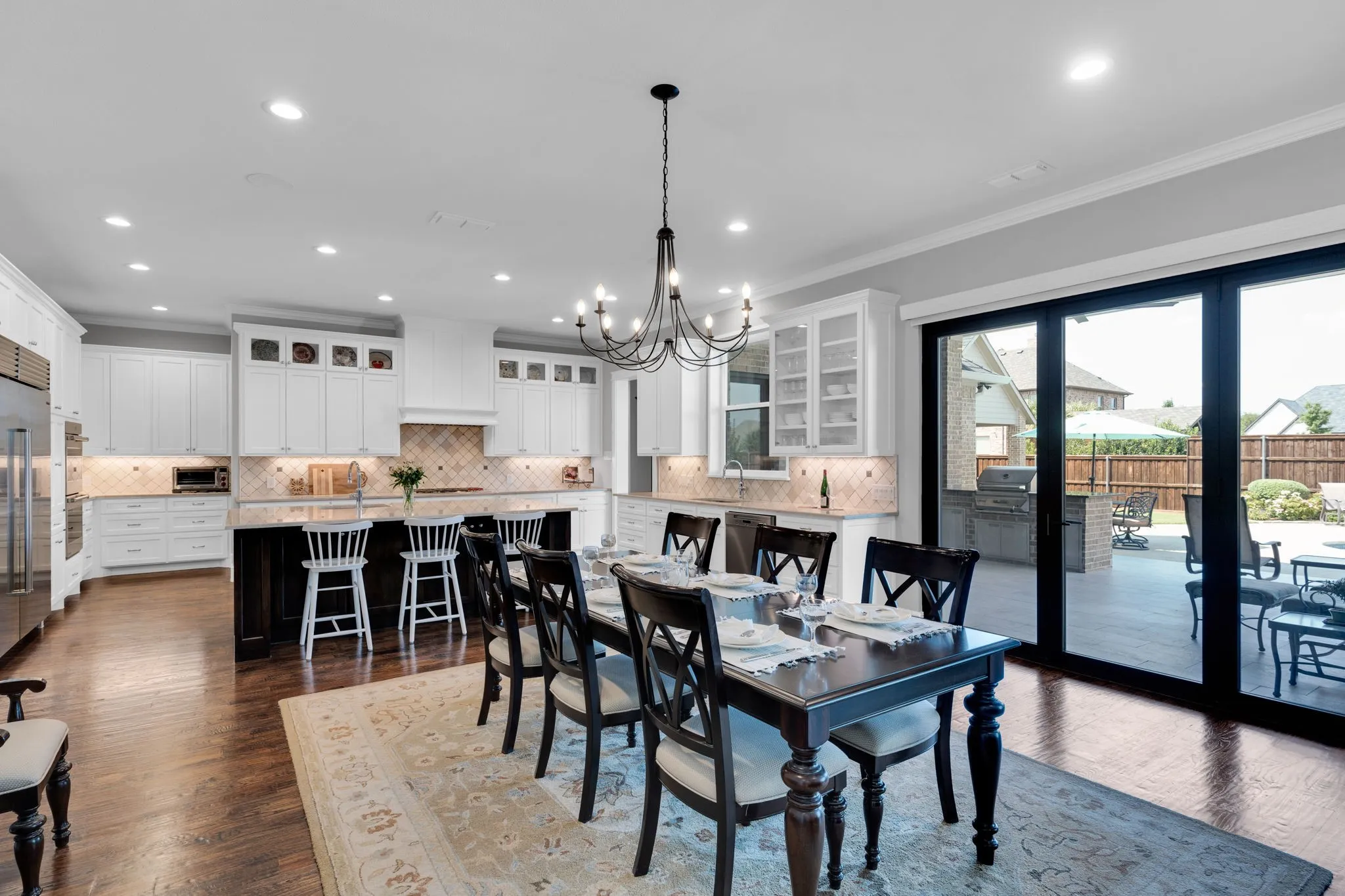 Dining room featuring a chandelier, dark wood finished floors, recessed lighting, and ornamental molding