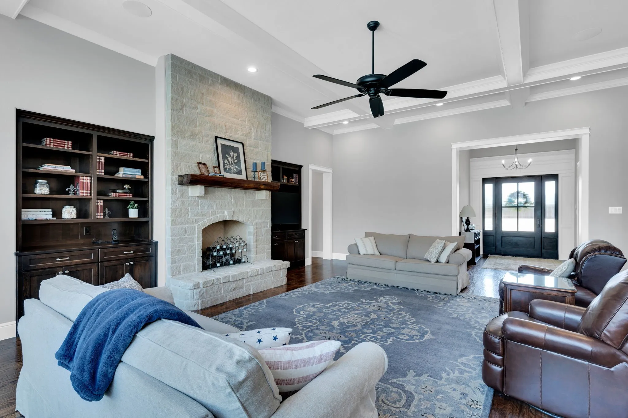 Living area with beamed ceiling, coffered ceiling, recessed lighting, a chandelier, and ceiling fan