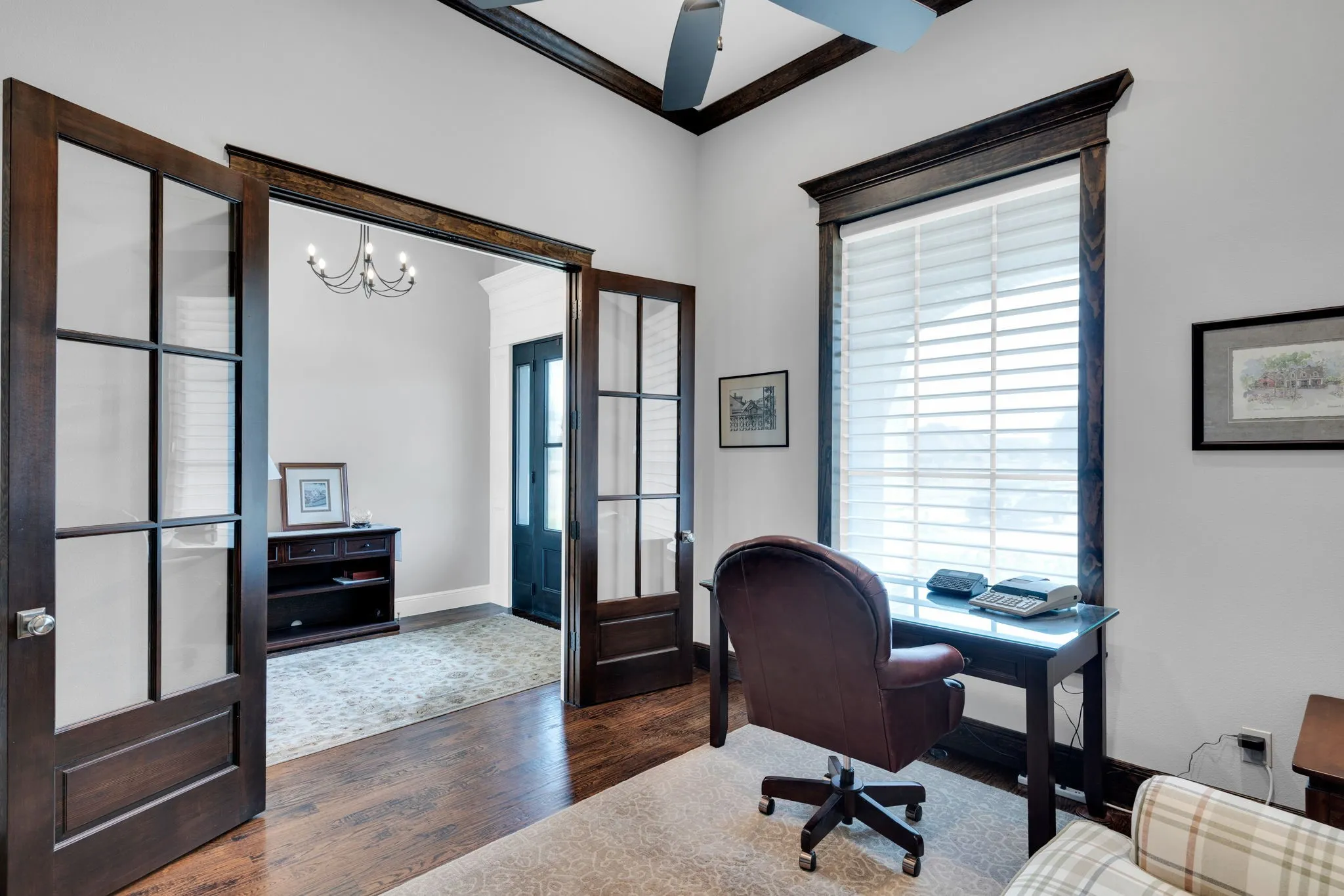Office space with dark wood finished floors, ornamental molding, and a chandelier