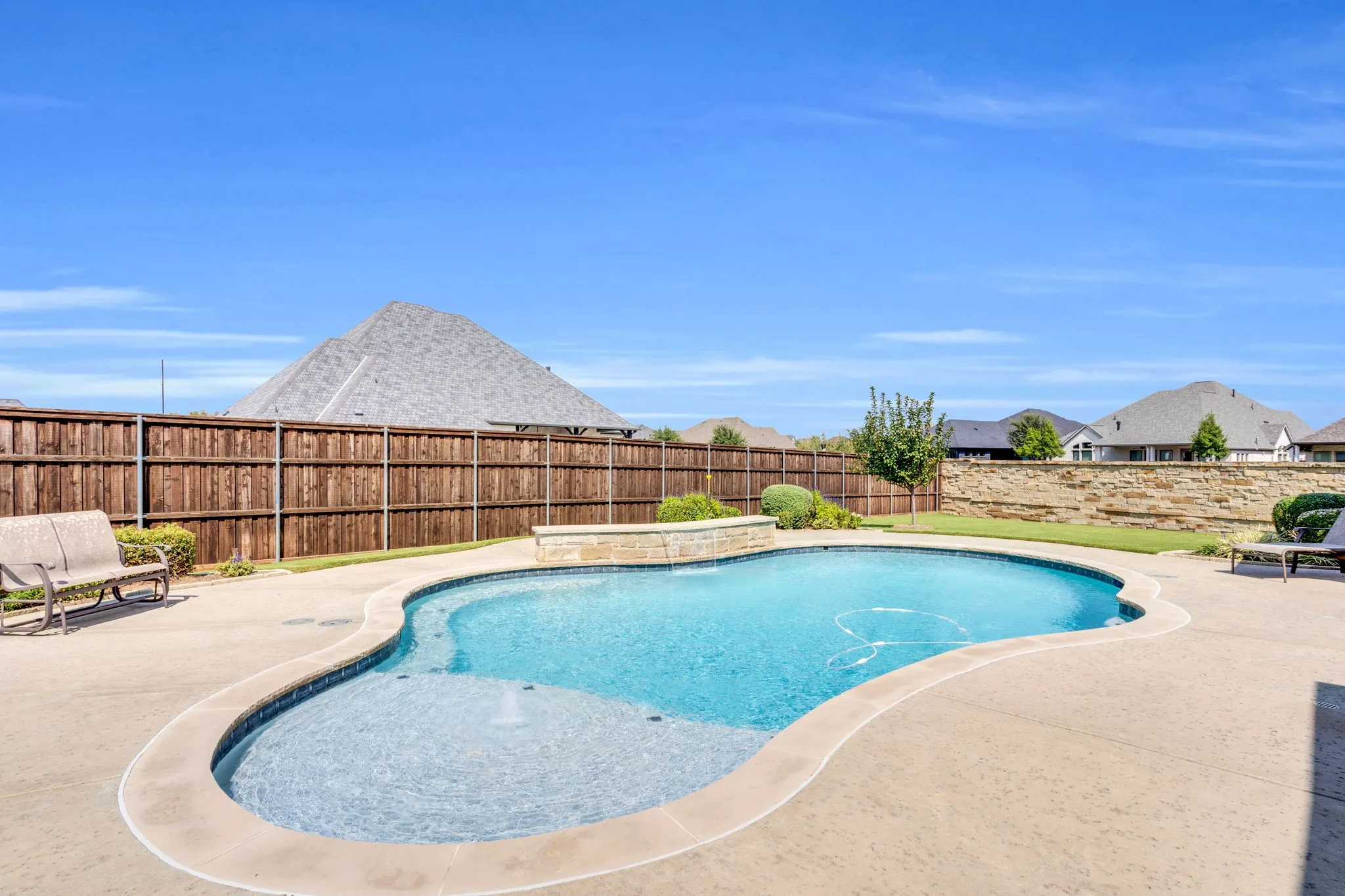 View of swimming pool with a patio area and a fenced backyard