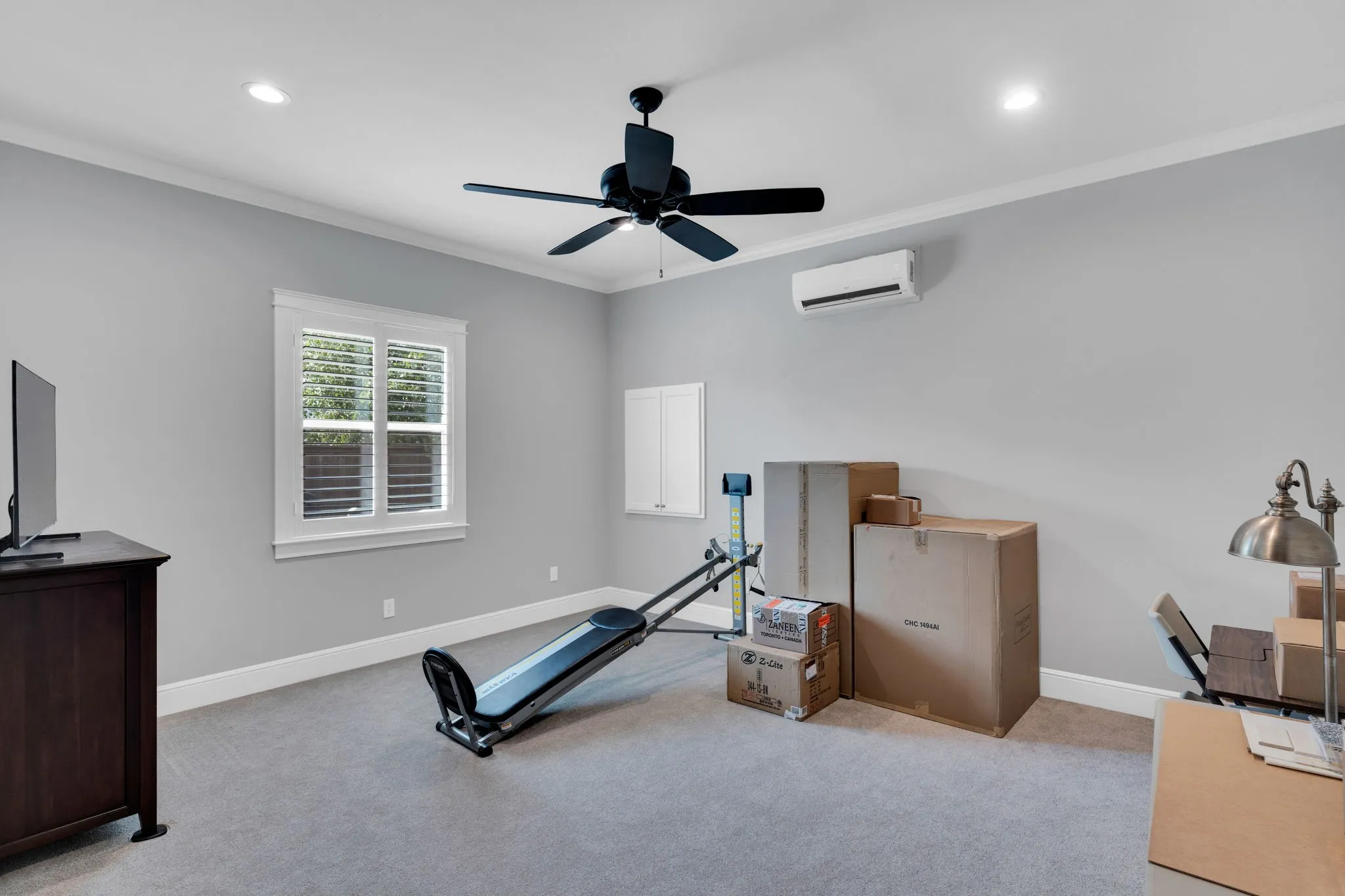 Workout area with crown molding, light carpet, ceiling fan, and recessed lighting