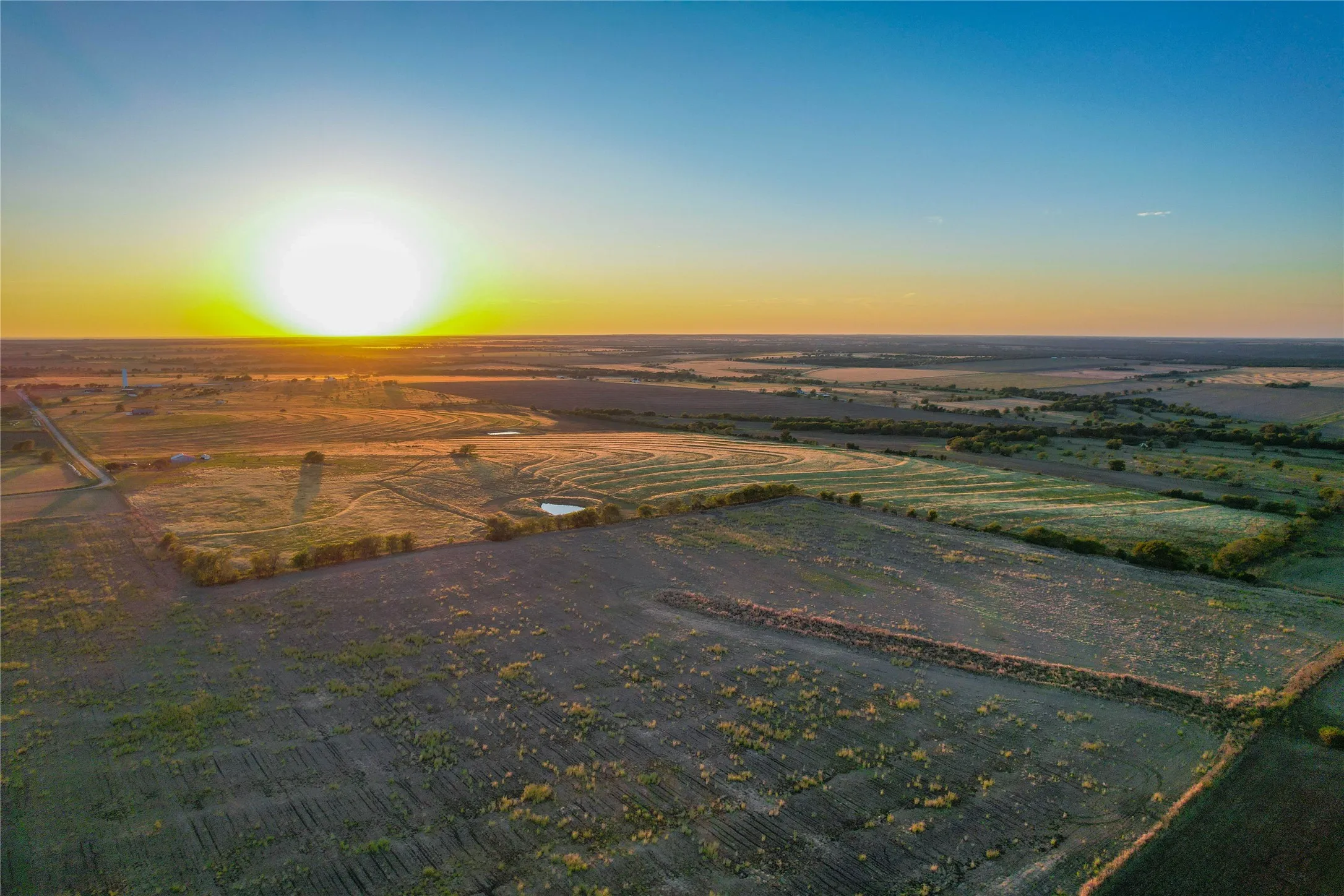 Aerial view of sparsely populated area featuring extensive farmland