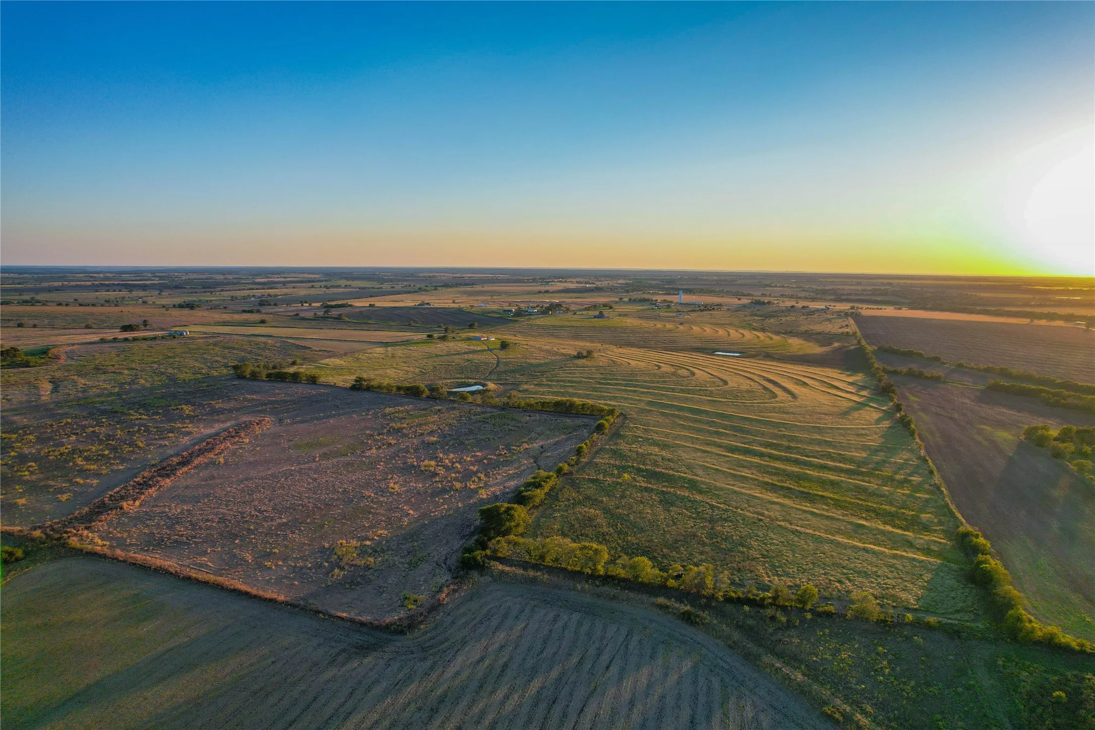Aerial overview of property's location featuring rural landscape and abundant farmland