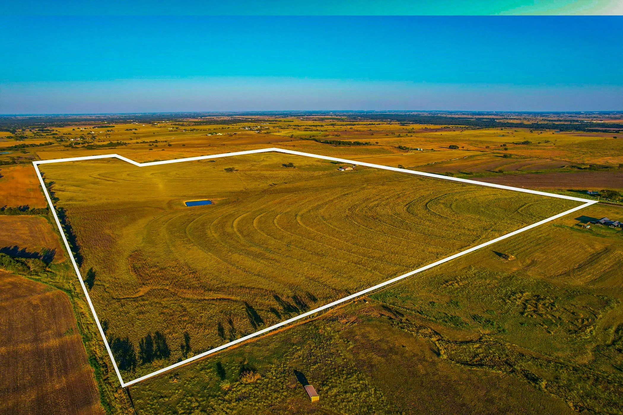 Aerial view of sparsely populated area featuring property boundaries highlighted