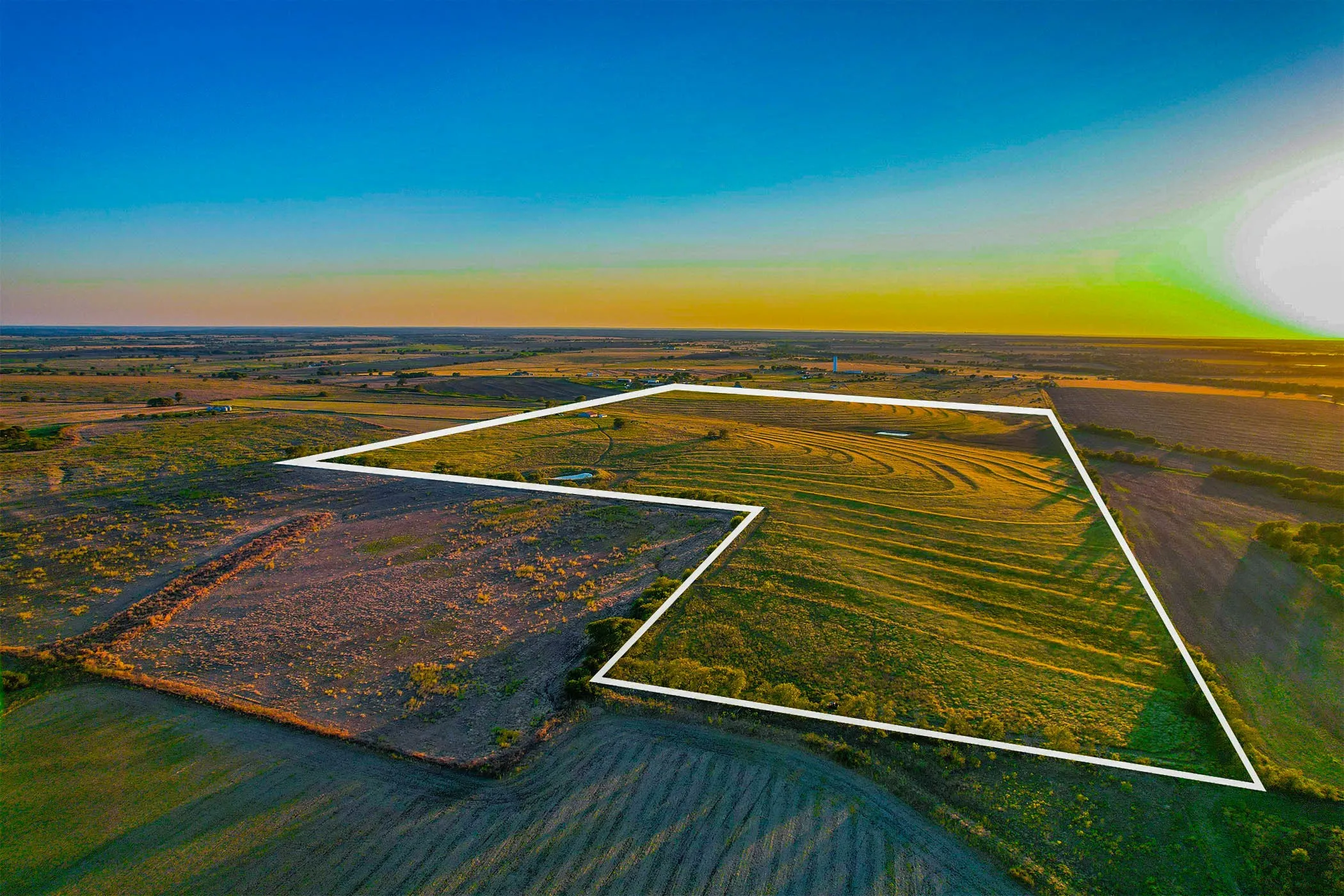 Aerial view at dusk of a rural view and property boundaries highlighted