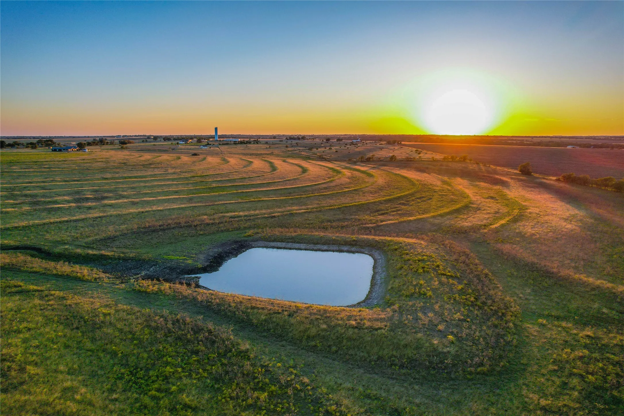 Aerial view at dusk of a water view and a view of rural / pastoral area