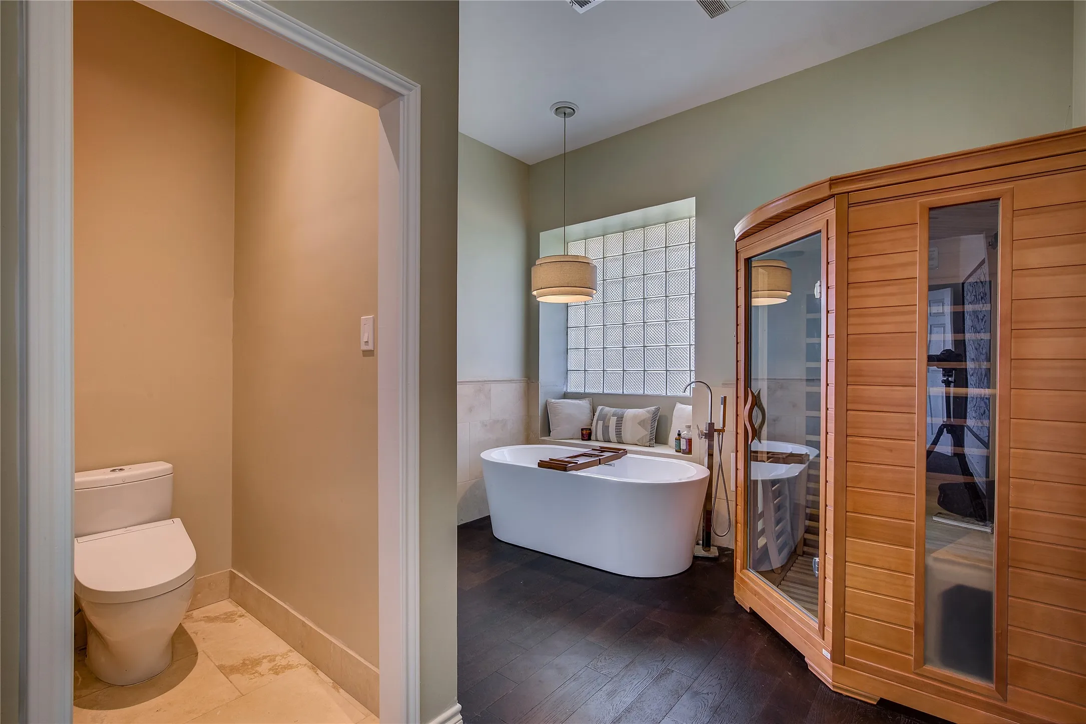 Primary bath is a spa retreat, with a literal sauna installed as well as a soaking tub. Plus a toilet and a separate bidet!