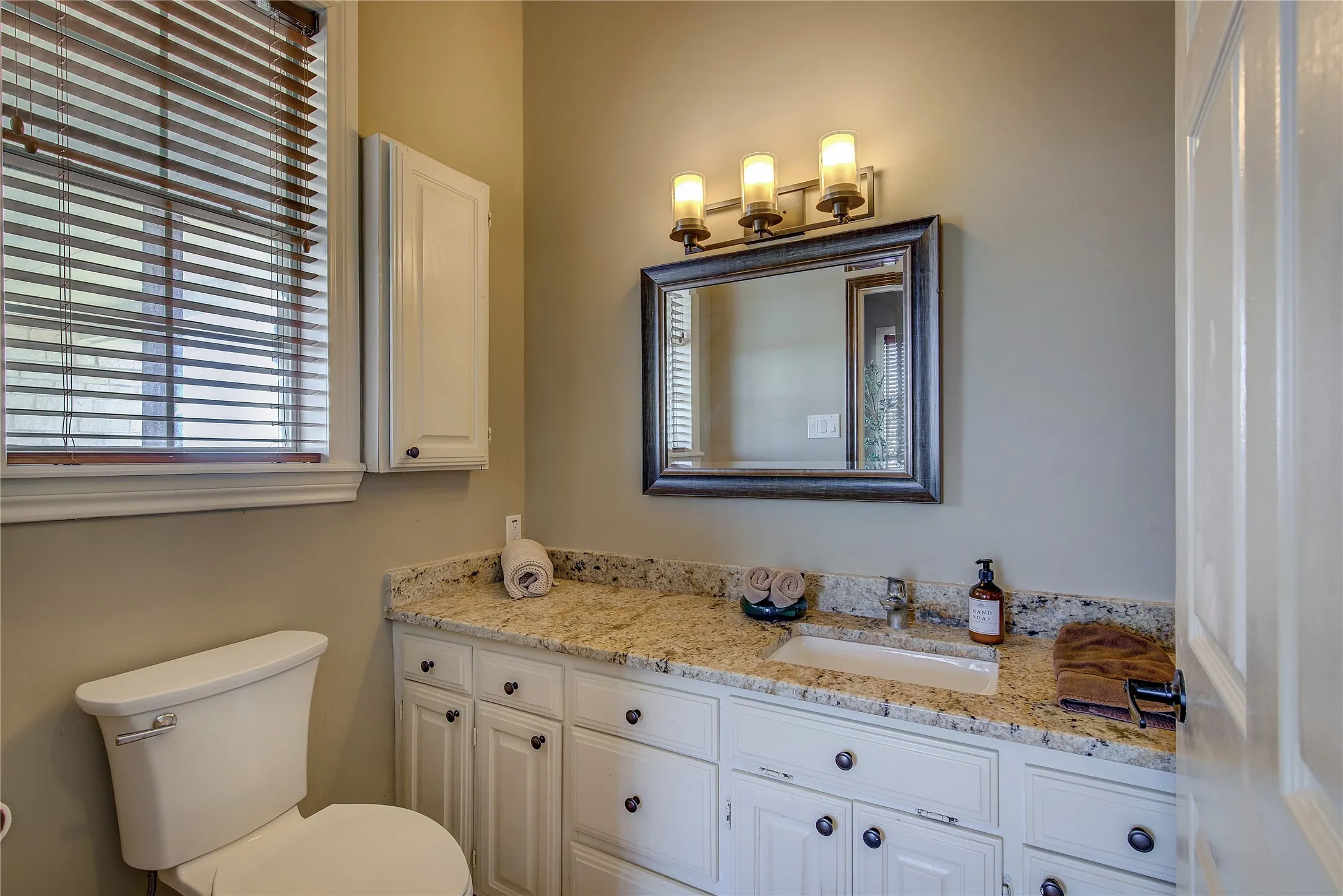 Ensuite to the other main floor bedroom; granite countertops and tiled shower with body sprays.