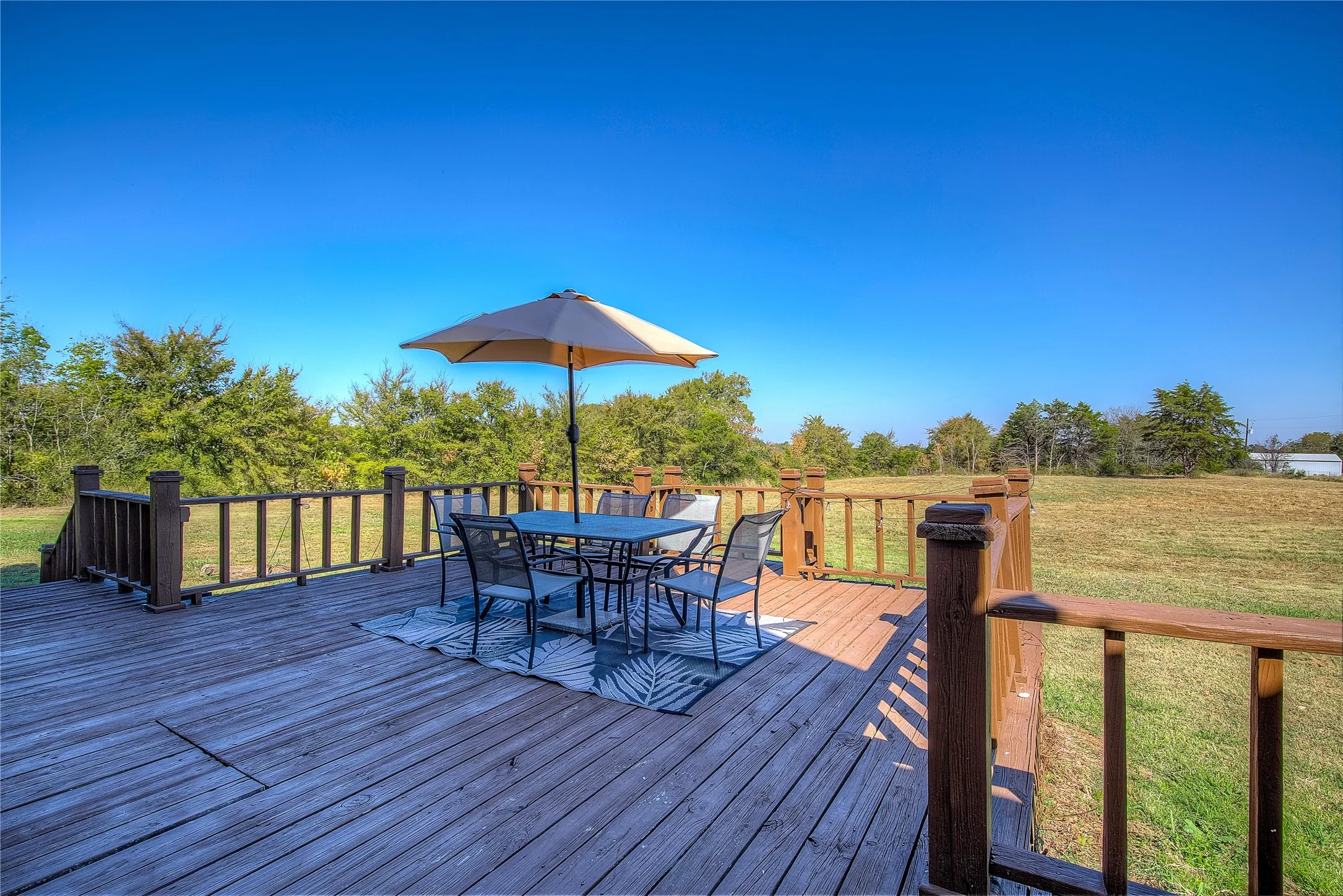 Back deck behind the house has pasture views, beautiful sunsets.
