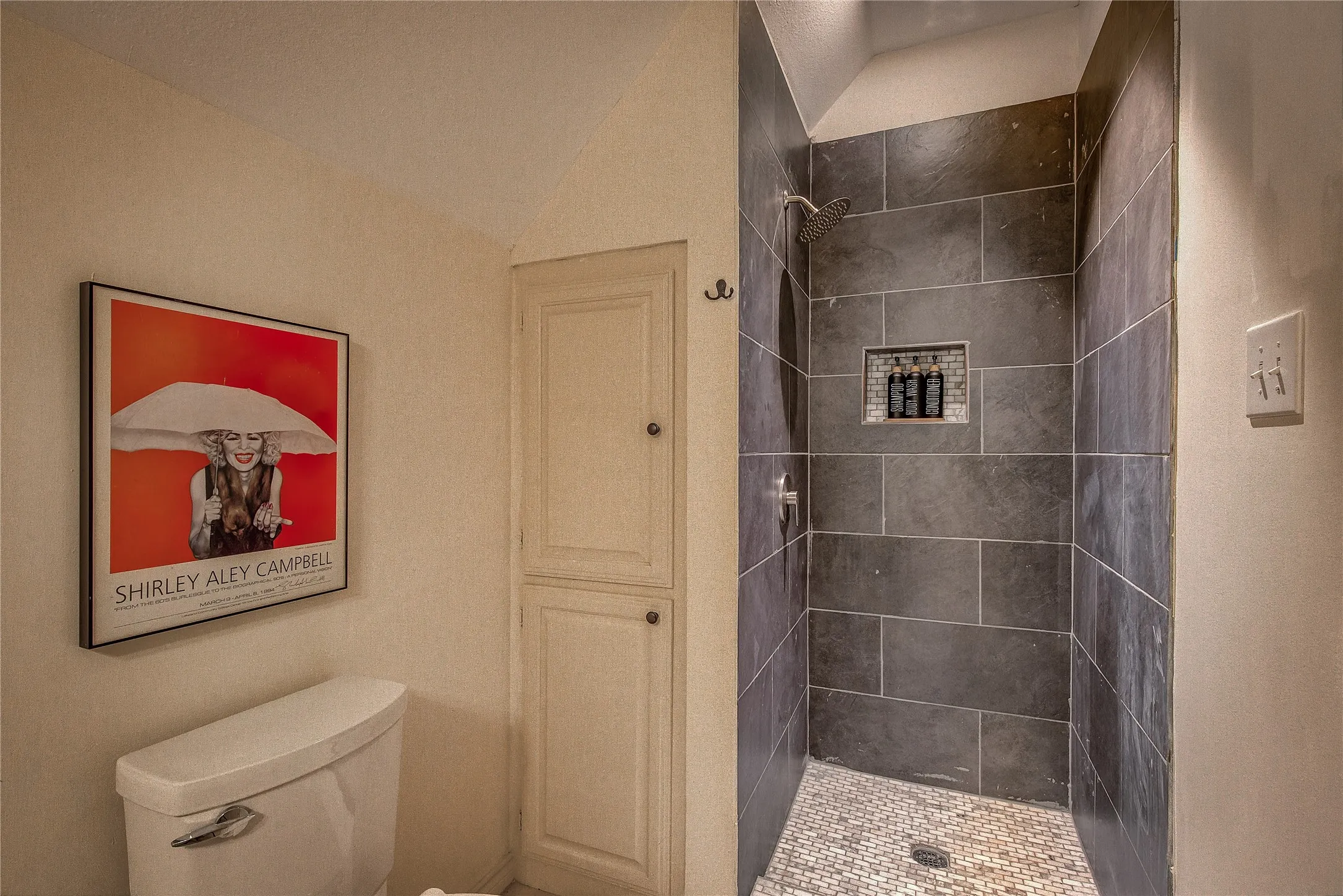 Man cave or Guest suite above the garage has french doors to a private balcony with views of the pond.