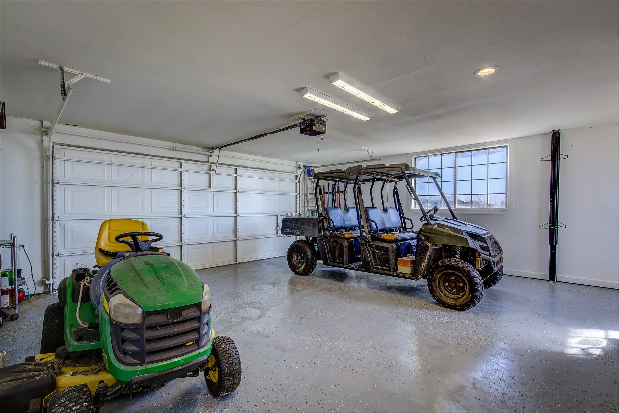 2-car garage has epoxy flooring, motorized garage door.
