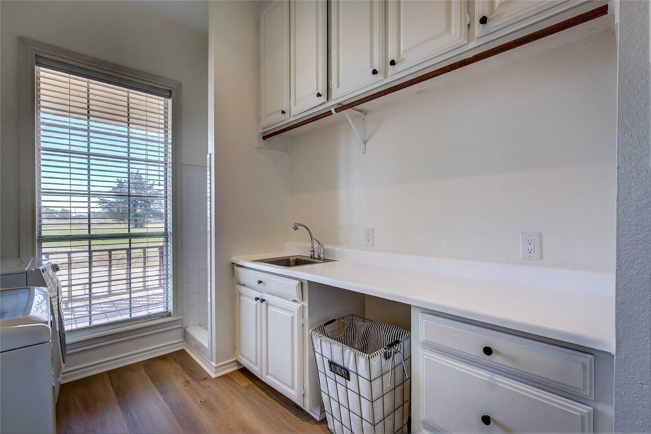 Laundry room is on main level-  has sink, shower, counter space and cabinets.