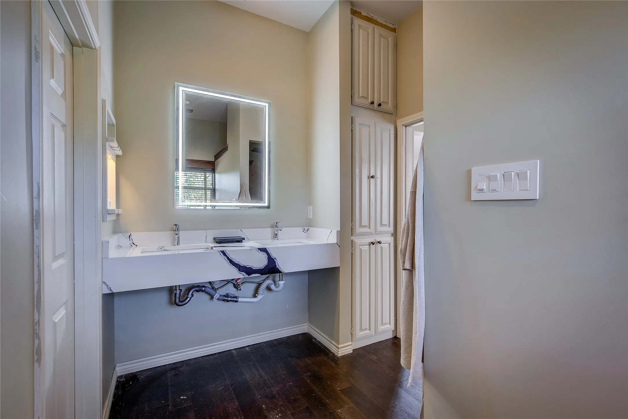 double sink with linen storage.  Two walk-in closets with custom closet systems.