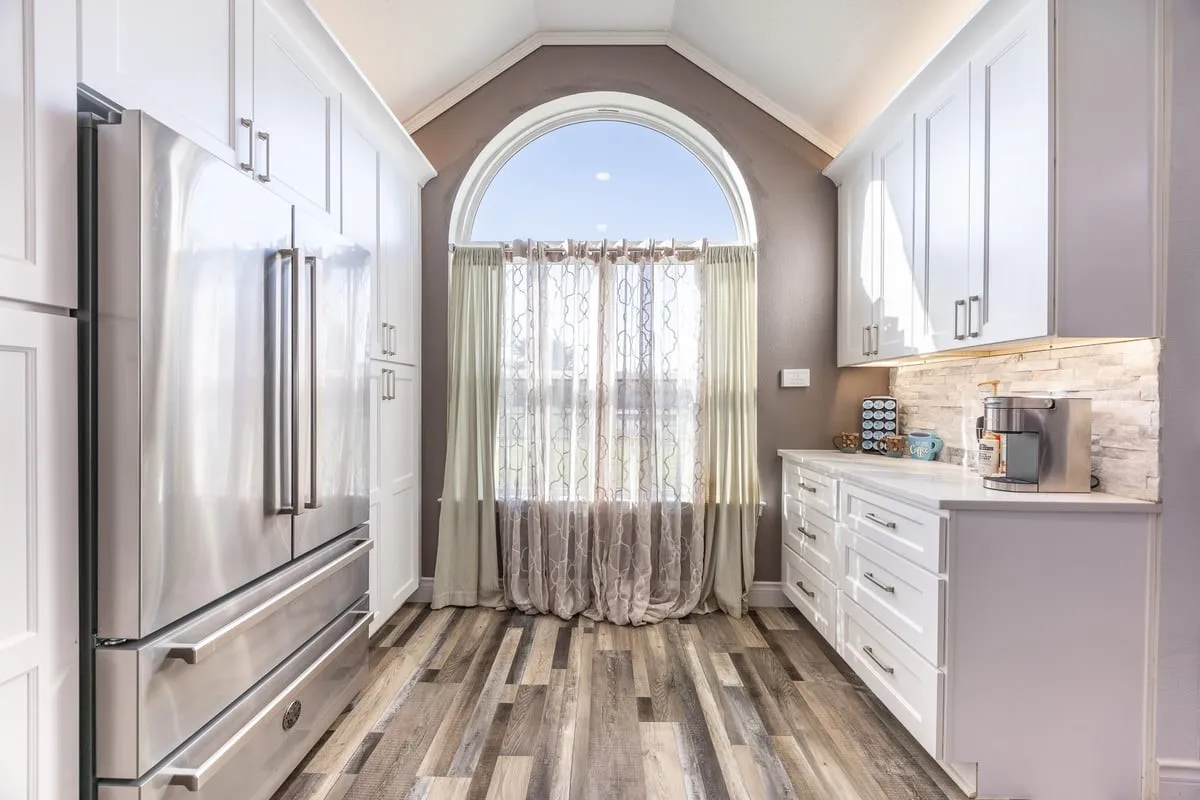 Main House kitchen coffee or wine bar. The refrigerator will convey with the home.