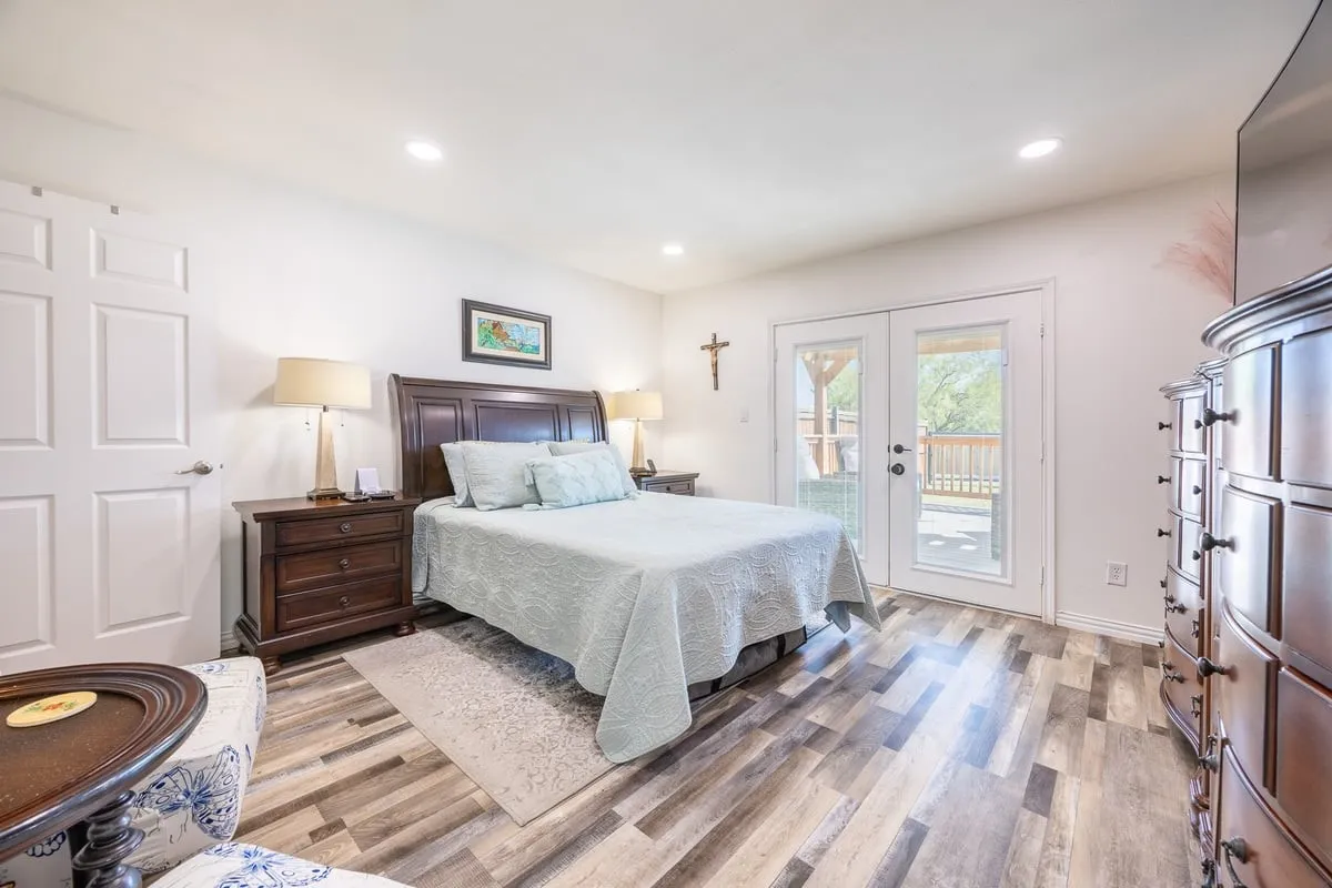 Guest House primary suite with private entry to the covered rear deck.
