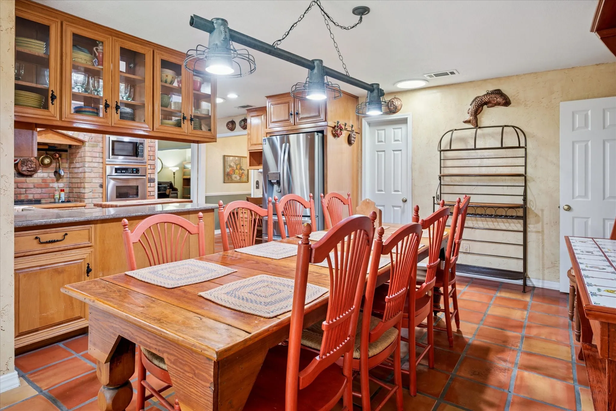 Dining space featuring dark tile patterned flooring and stairway