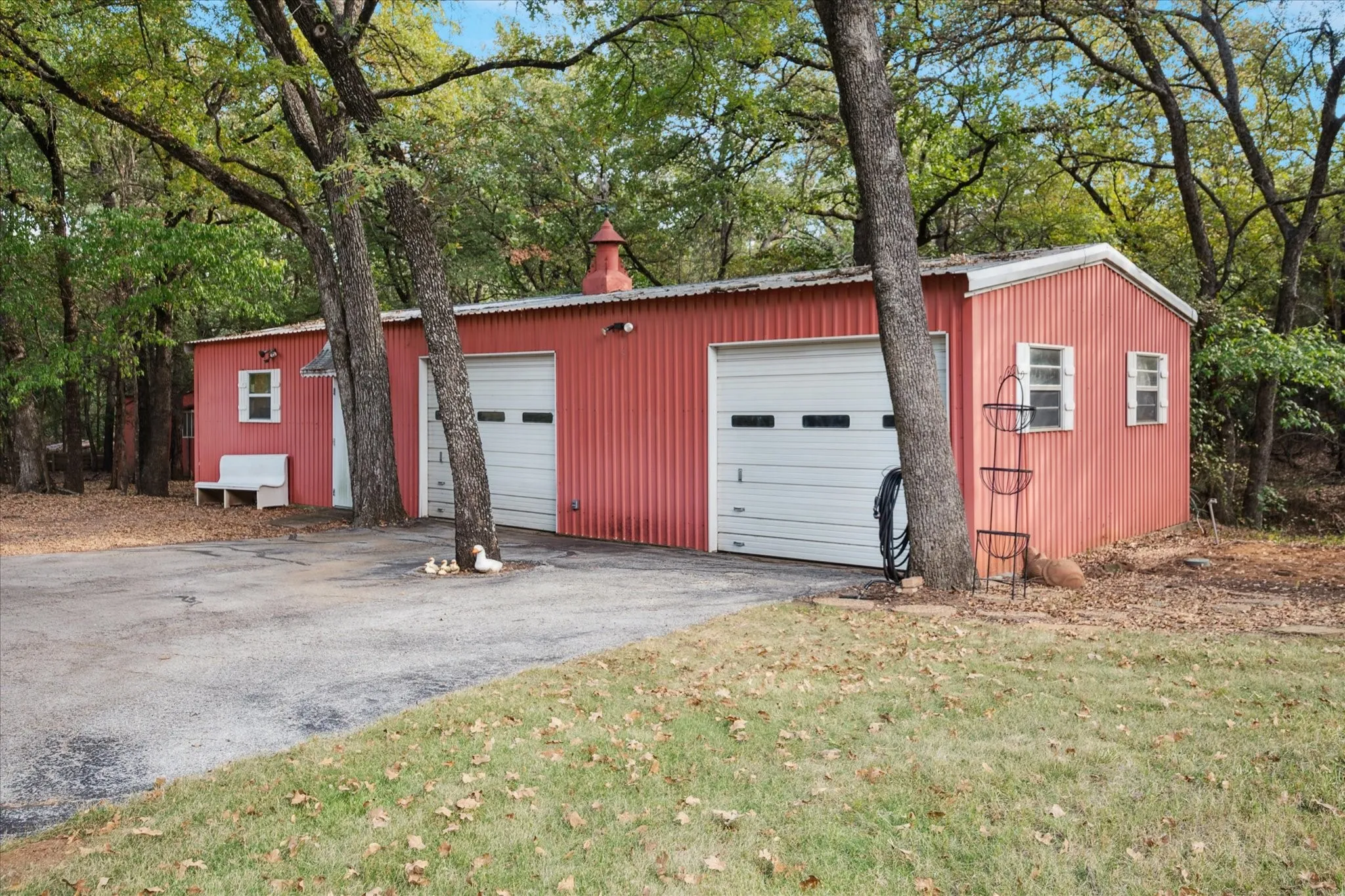 Detached workshop featuring view of wooded area