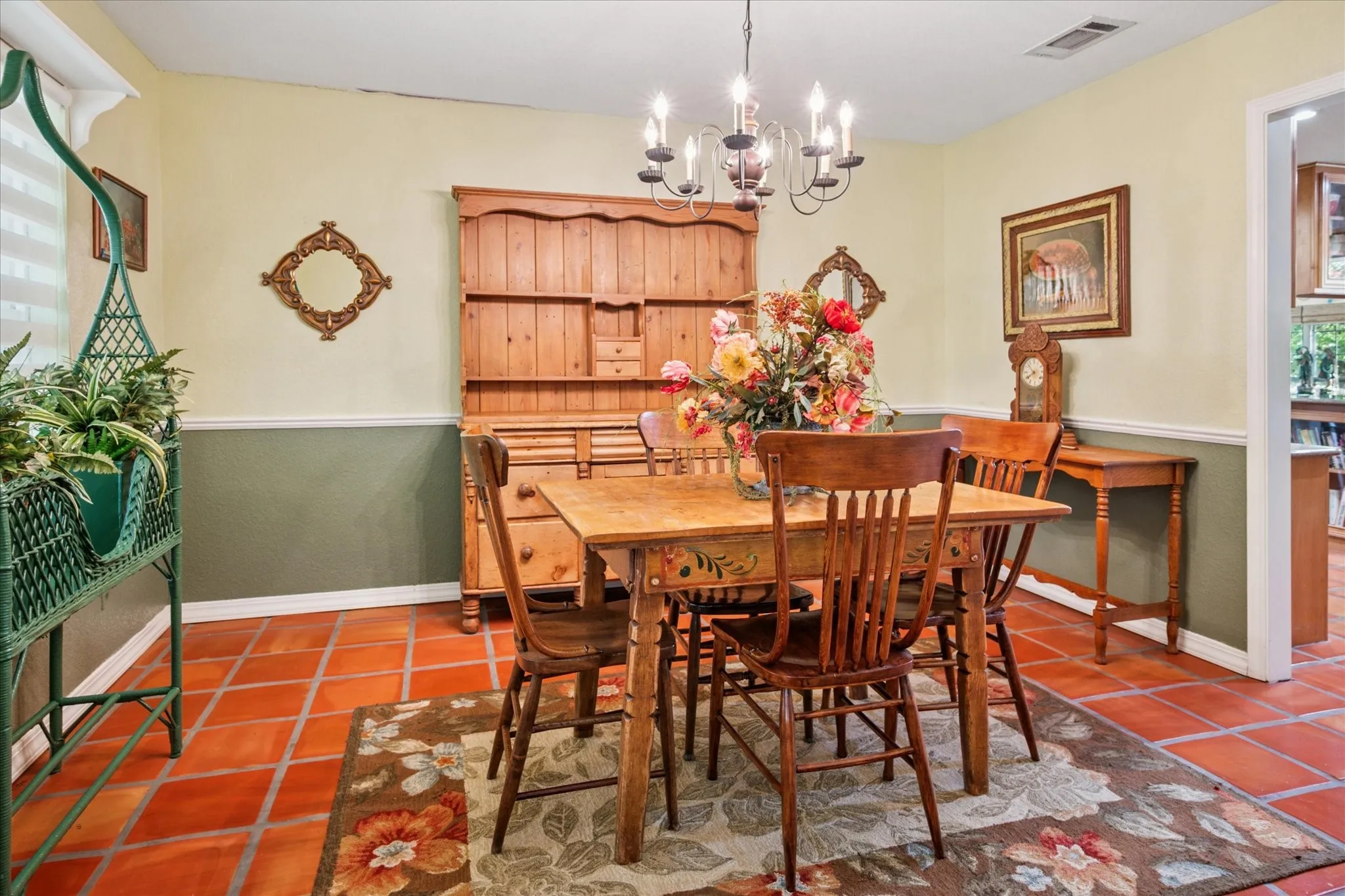 Dining space featuring healthy amount of natural light, tile patterned floors, and a chandelier
