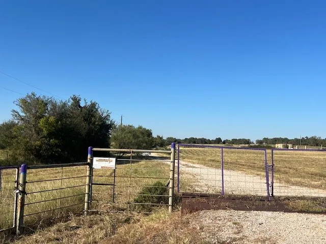 View of yard featuring a view of rural / pastoral area and a gate