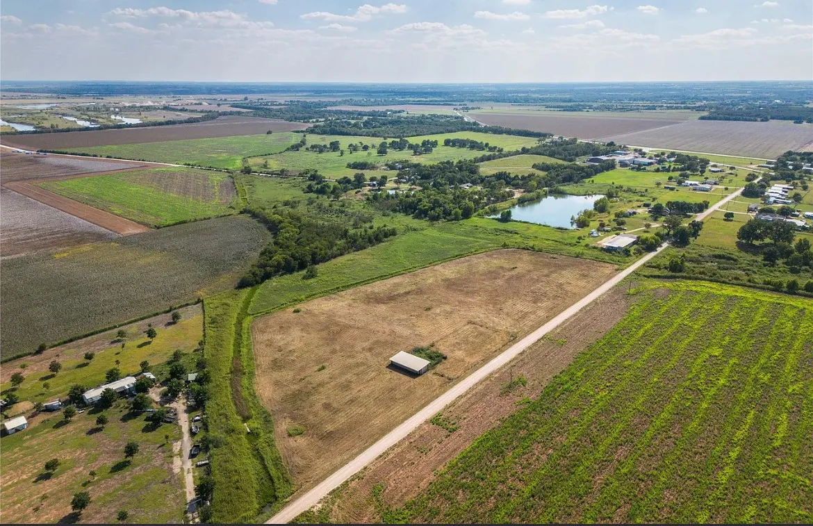 Overview of rural landscape featuring rows of crops
