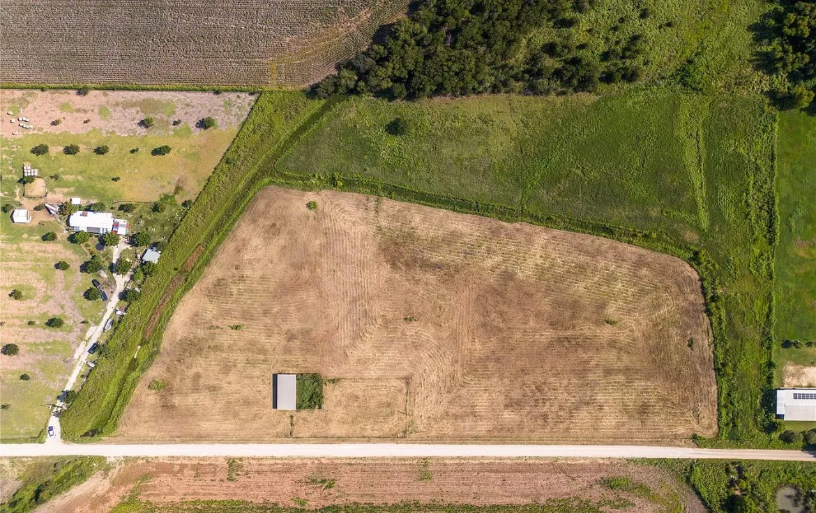Aerial view of property and surrounding area featuring rural landscape and extensive farmland