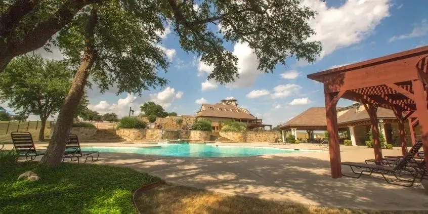 Community pool with a patio and a pergola